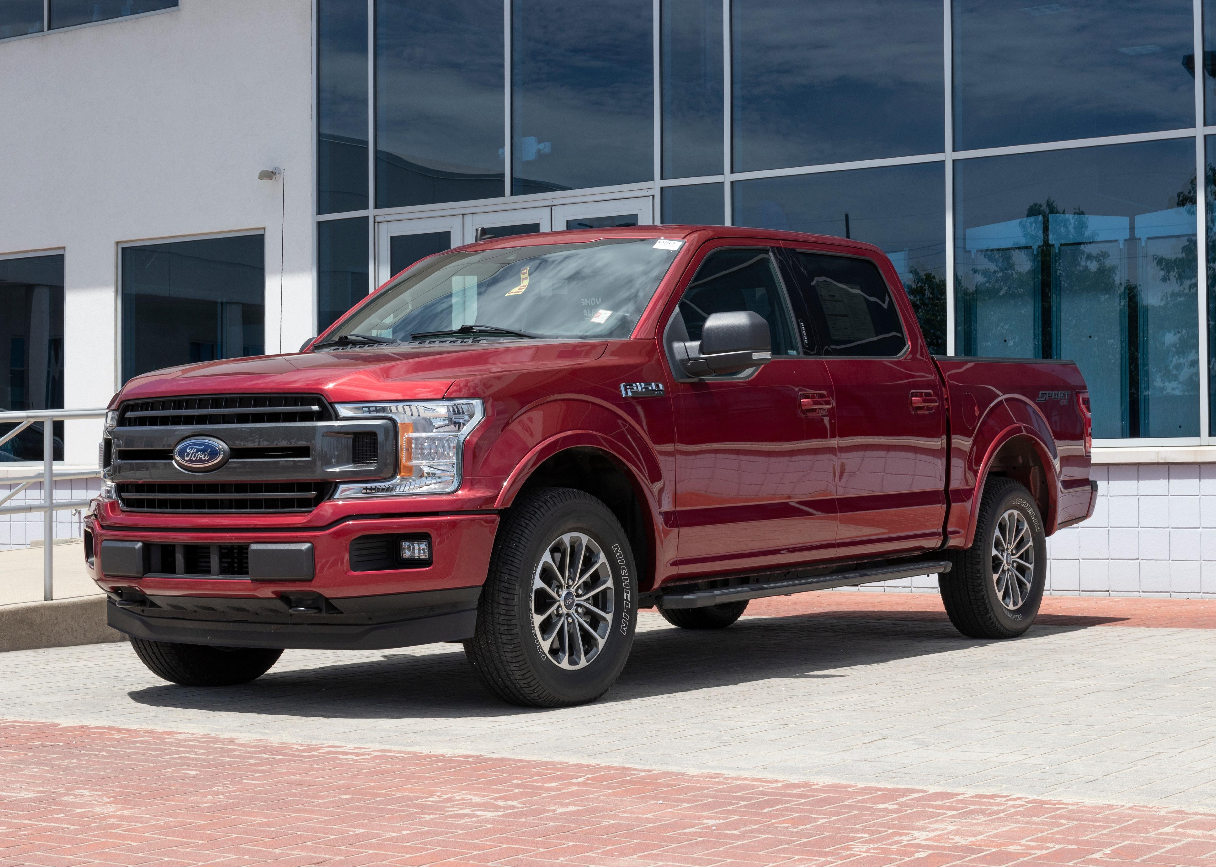 Red Ford F-150 on display at dealership. 