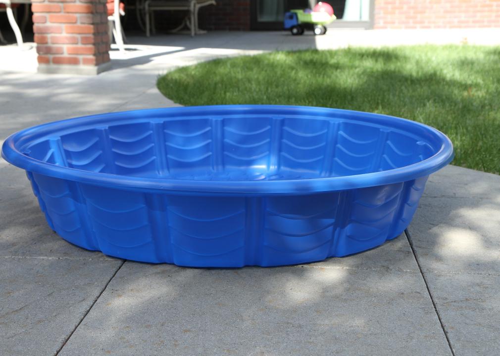 Small blue kiddie pool on concrete.