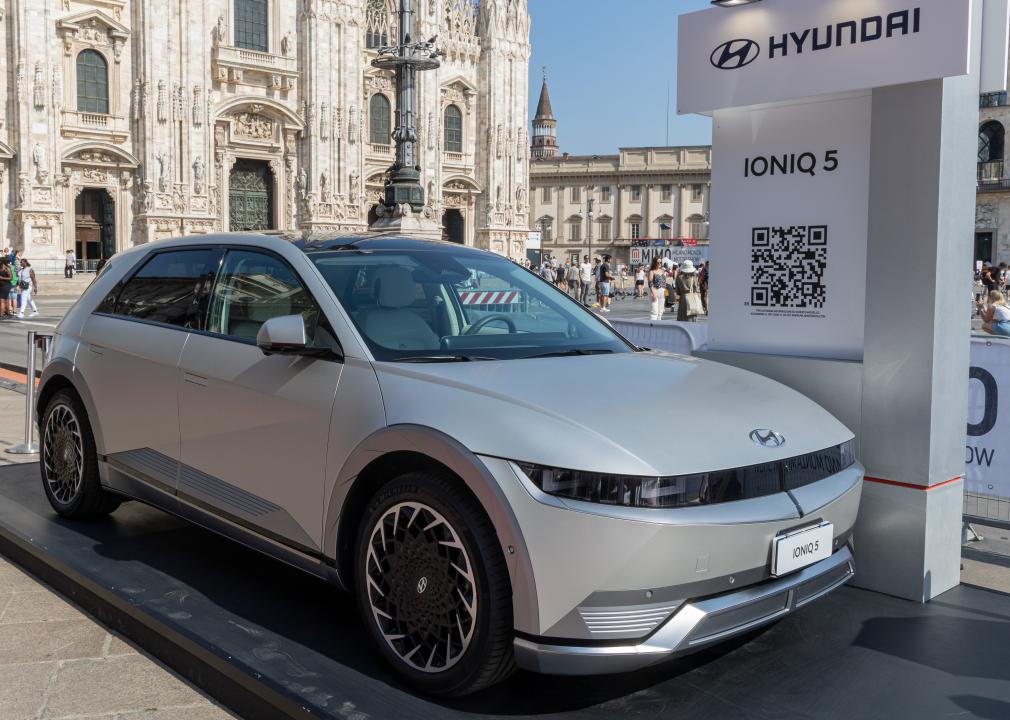 A light silver Hyundai IONIQ at the Milan Monza Motor Show, parked outside.