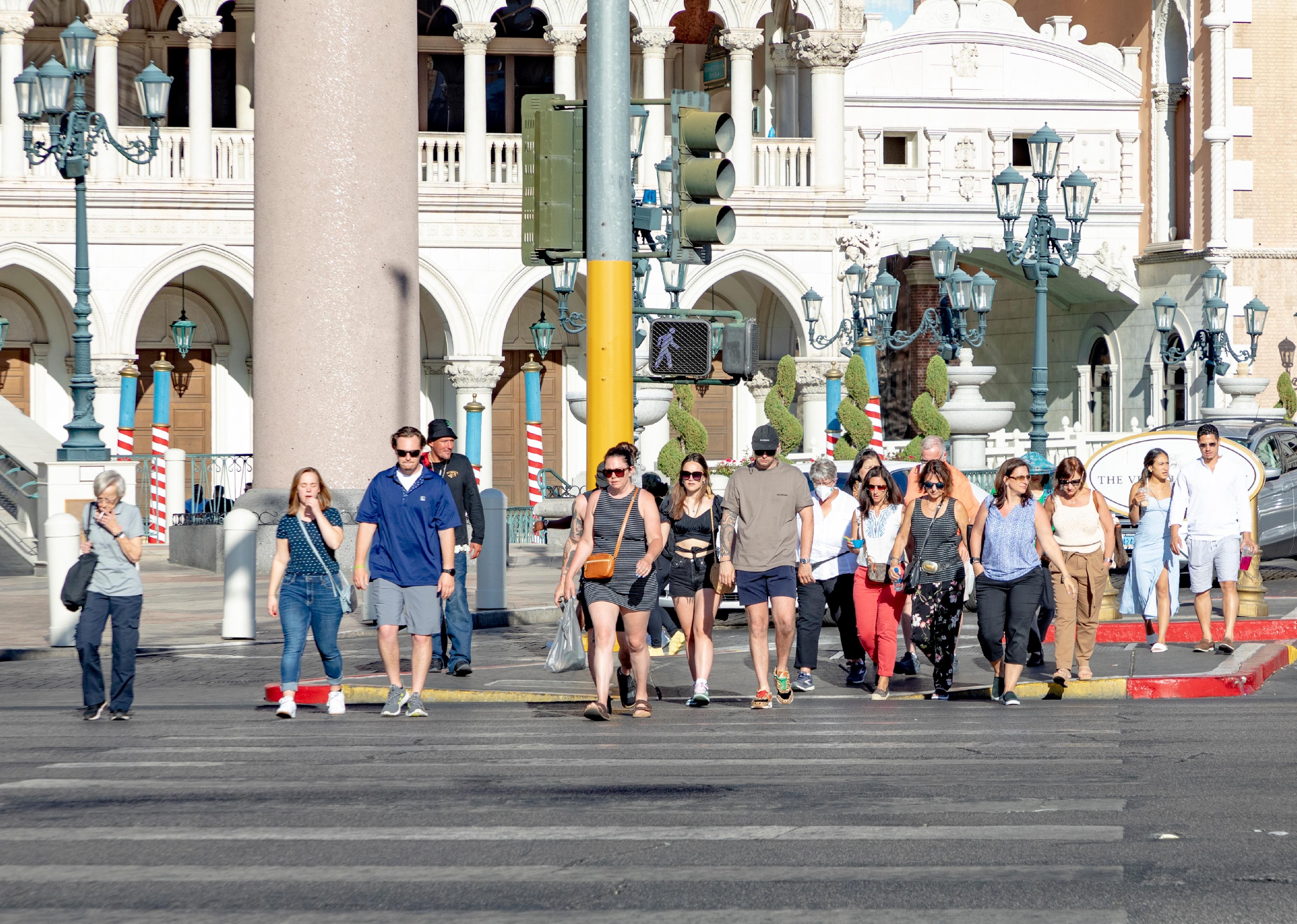 Tourists in Las Vegas crossing the street in daytime at a pedestriam crossing