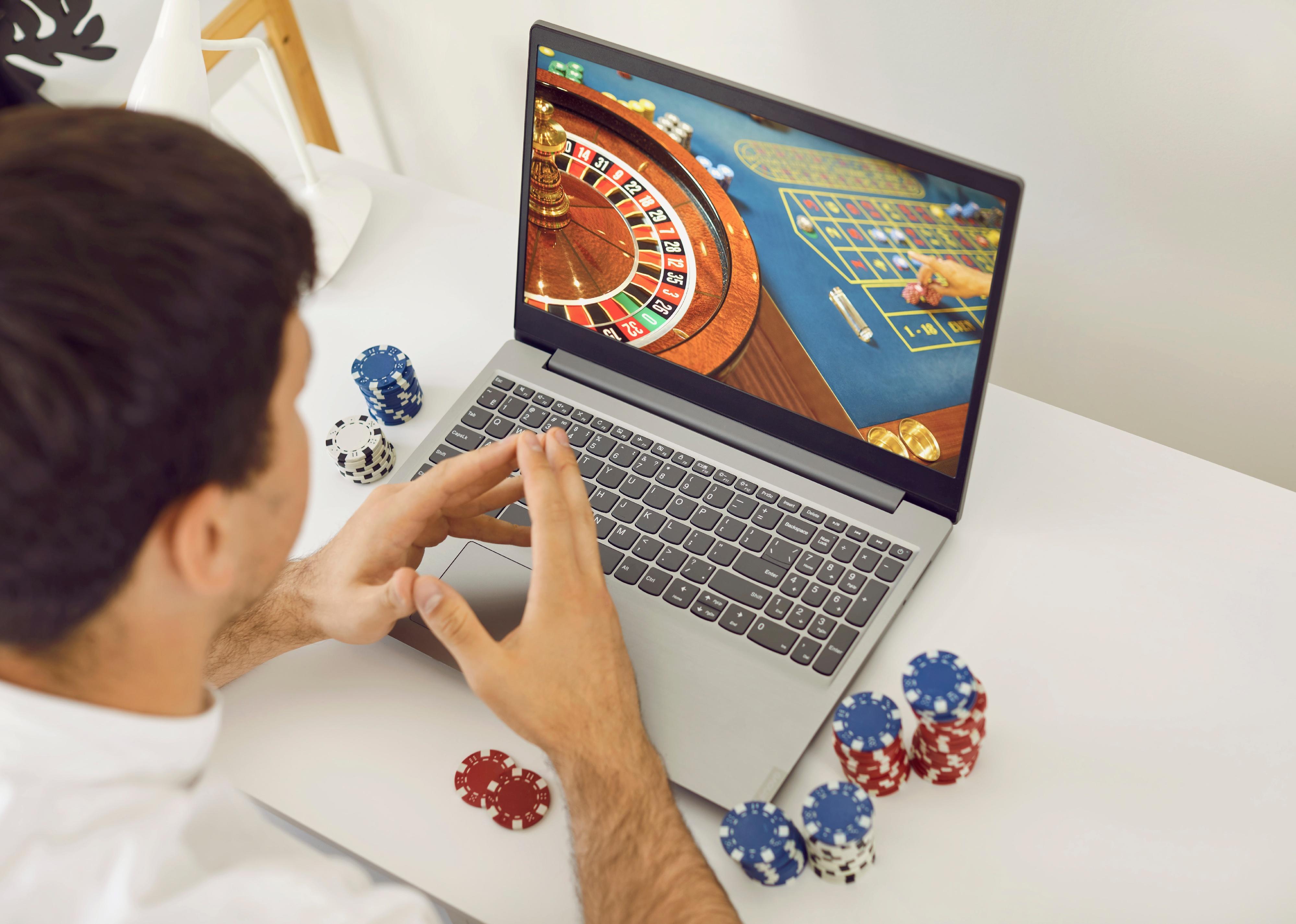 Young man playing roulette on an online casino club website.