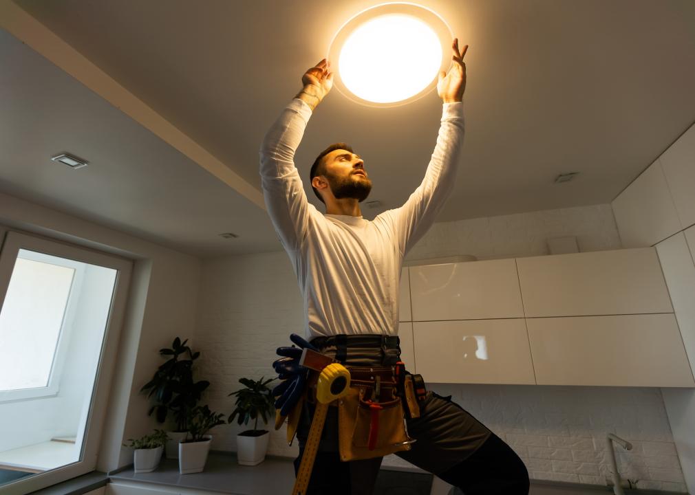 Electrician installing electric lamps.