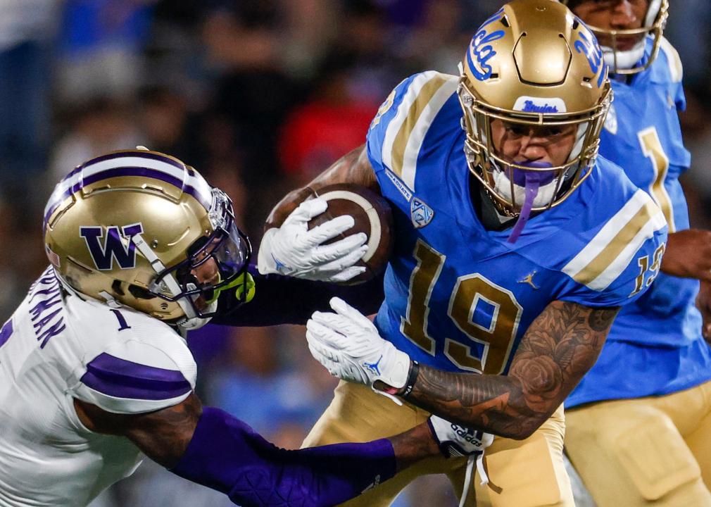 UCLA wide receiver tackled by a Washington cornerback.