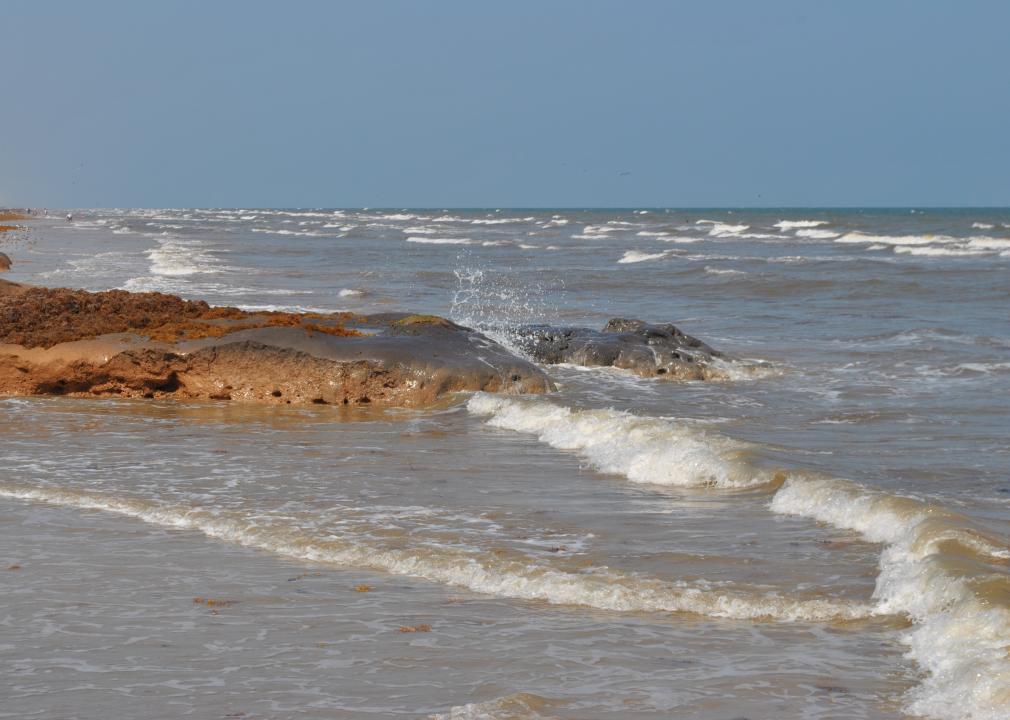 Ocean waves, crashing onto a beach.