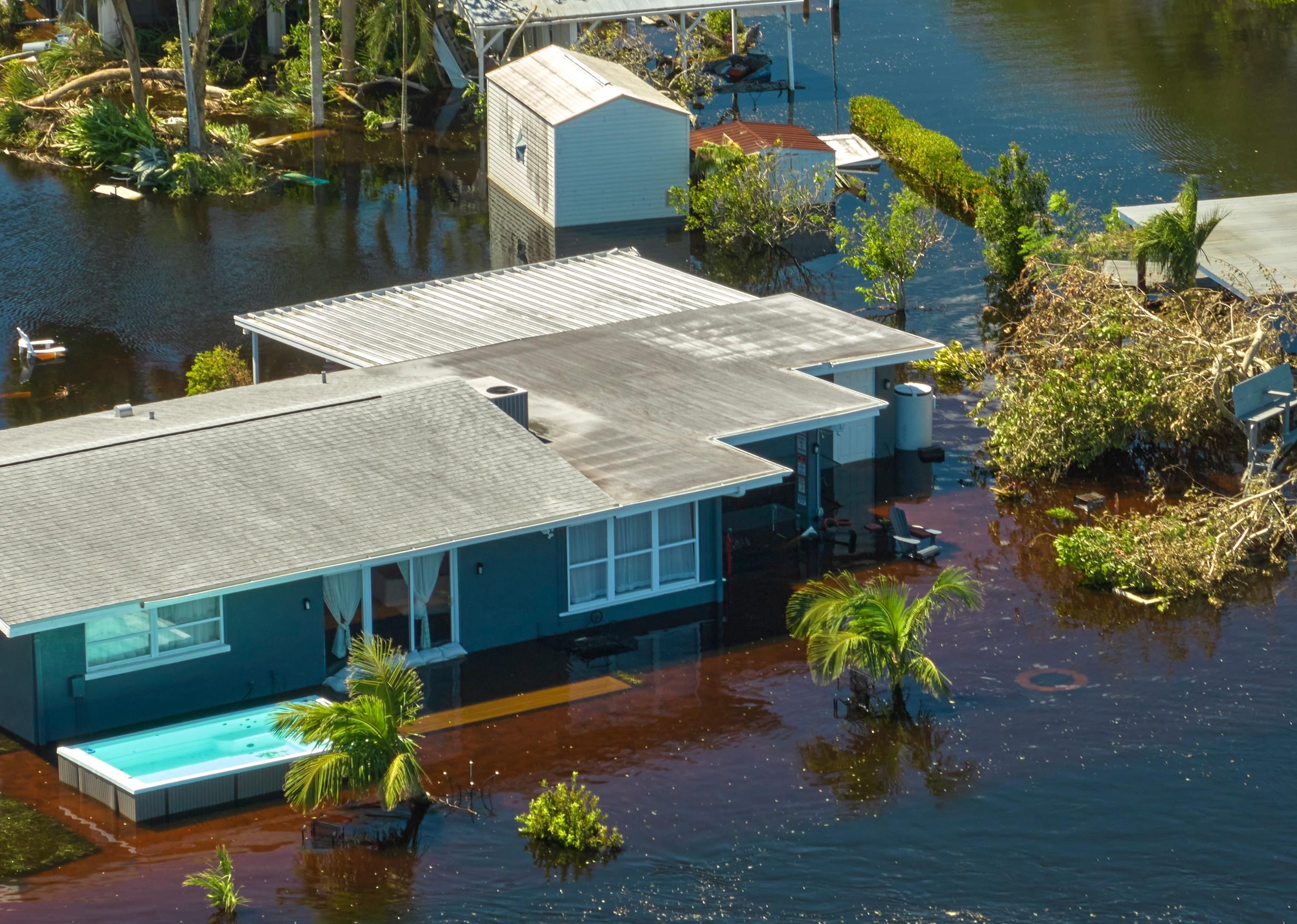 Flooded house by hurricane Ian rainfall in Florida residential area.