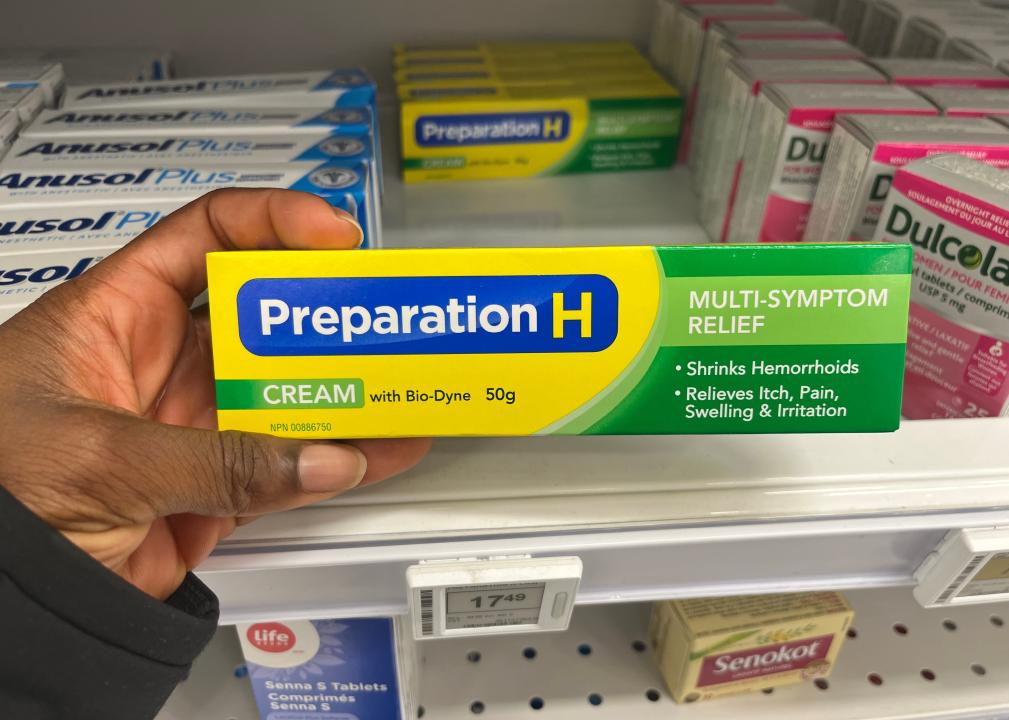 Person holding a box of Preparation H.