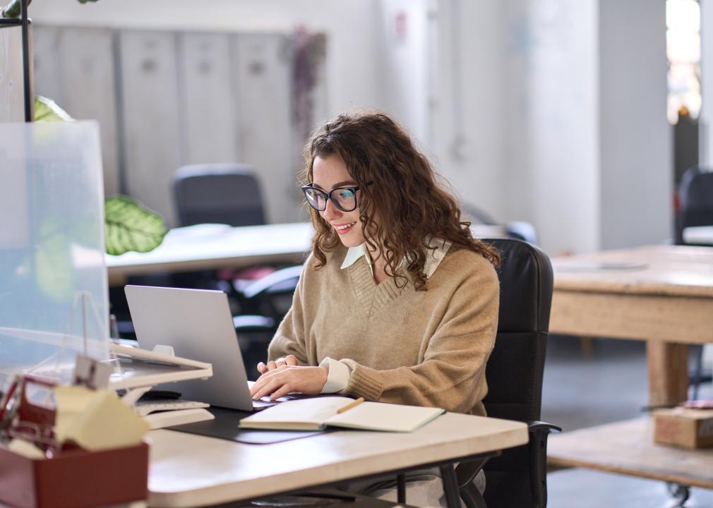 Smiling worker using computer.