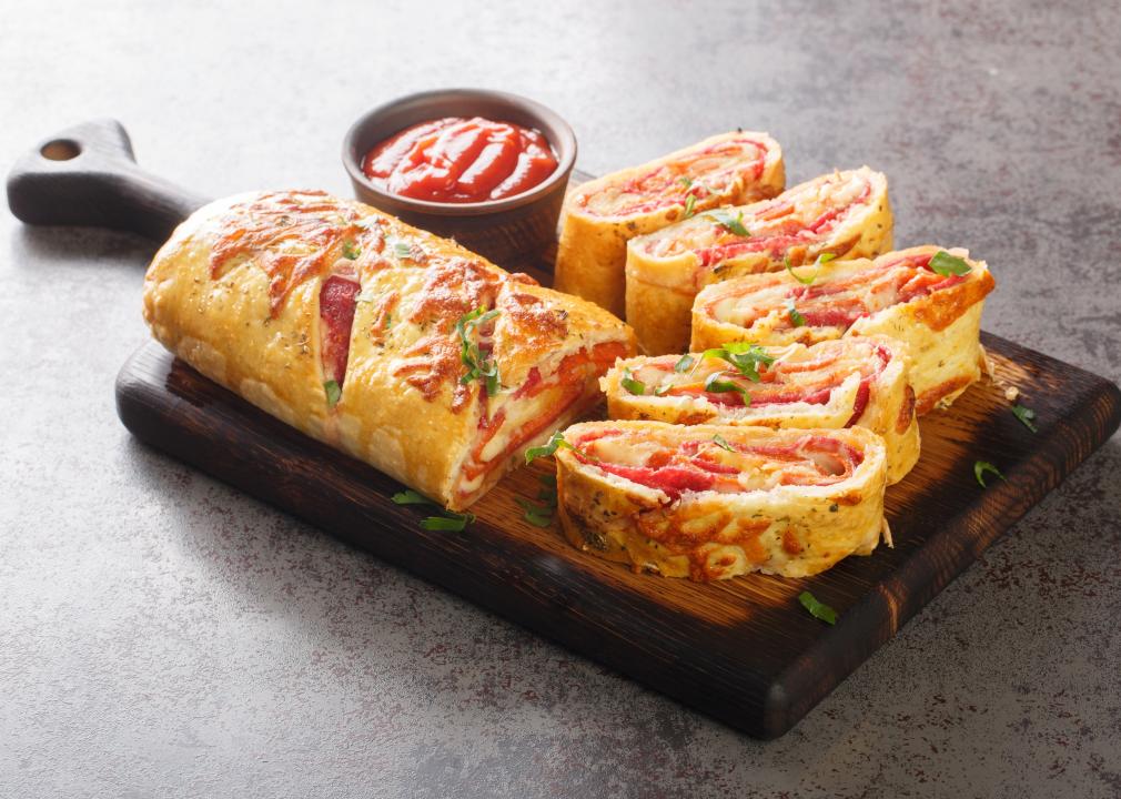 Hot stromboli roll stuffed with salami sausage and mozzarella cheese.