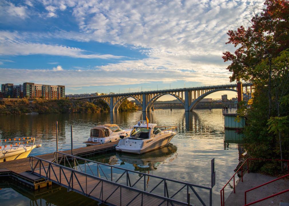 Autumn on the Tennessee River with boats docked and the Henley Street Bridge.