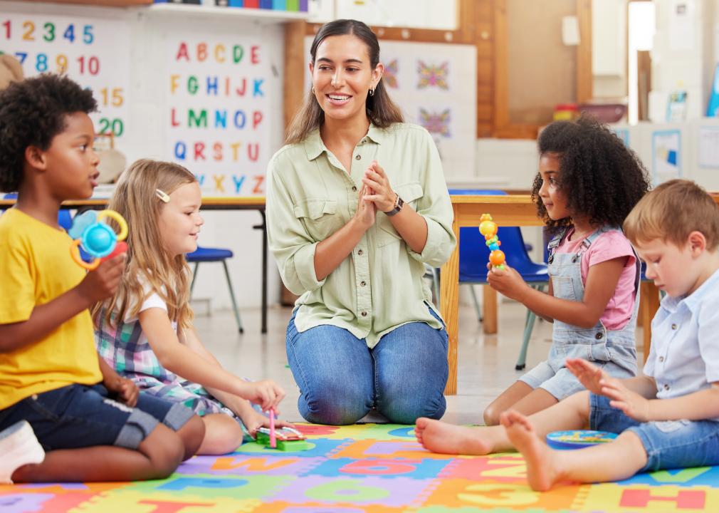 A teacher singing with her preschool children.