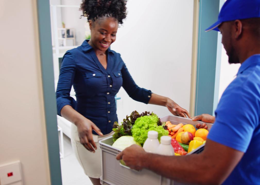 Grocery delivery man arriving at a woman's door.