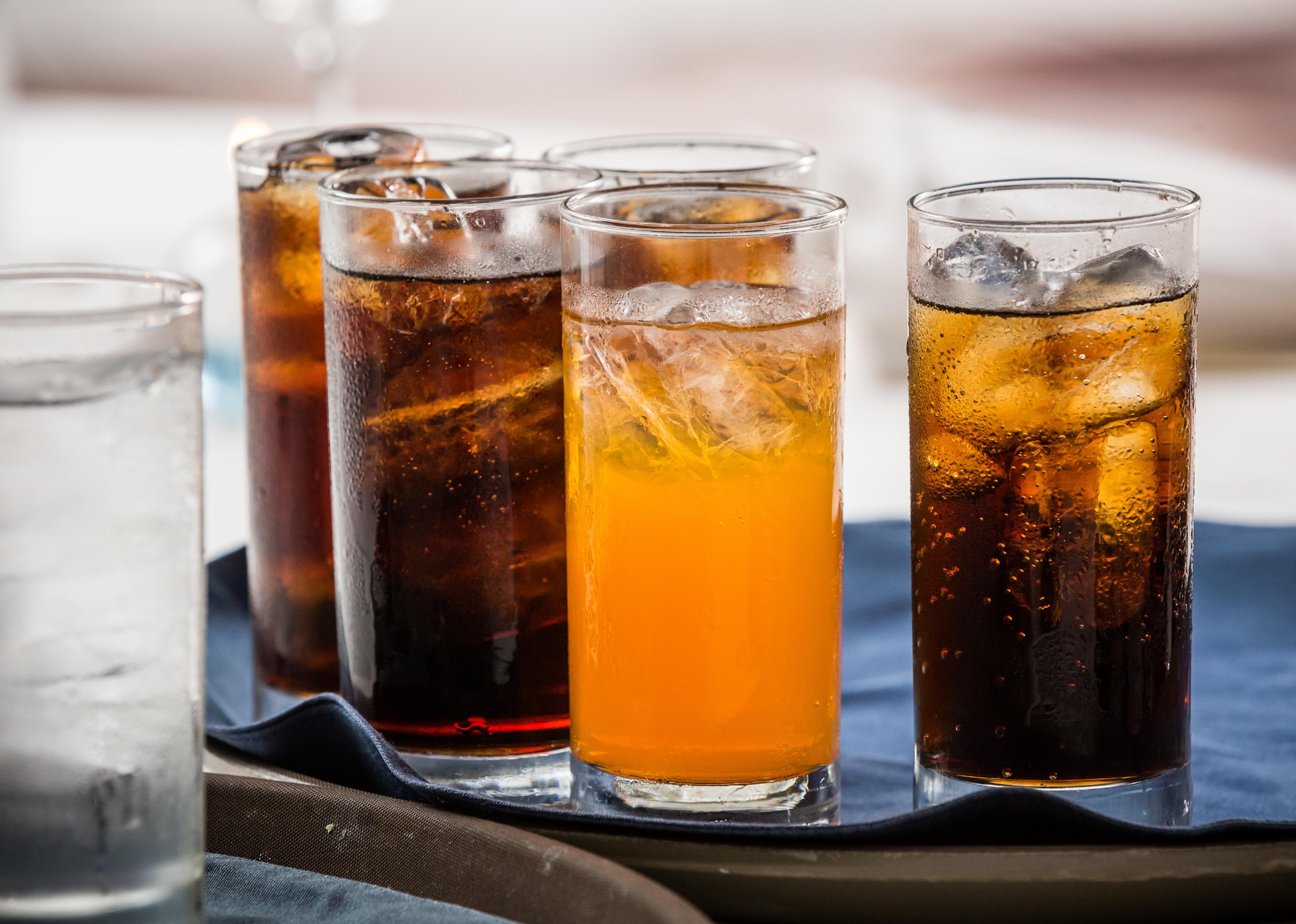 An array of soft drinks on a tray.