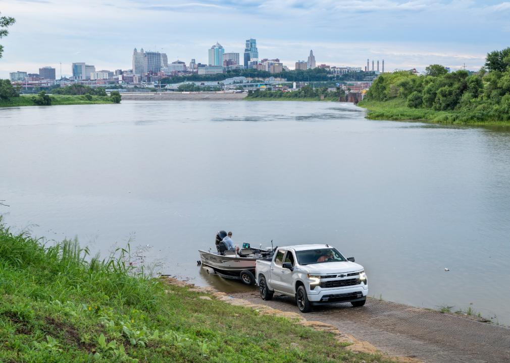 Fishing boat launching at Kaw Point ramp with a cityscape of Kansas City.