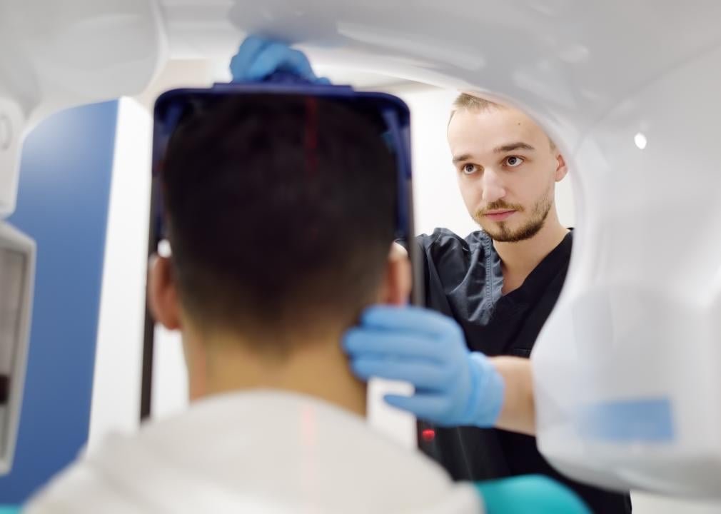 A technician sets up a digital X-ray on a patient.