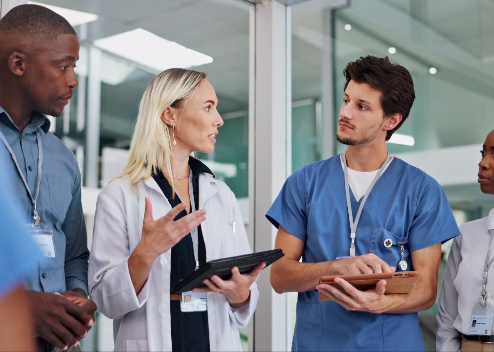 Health care staff having a standing meeting.