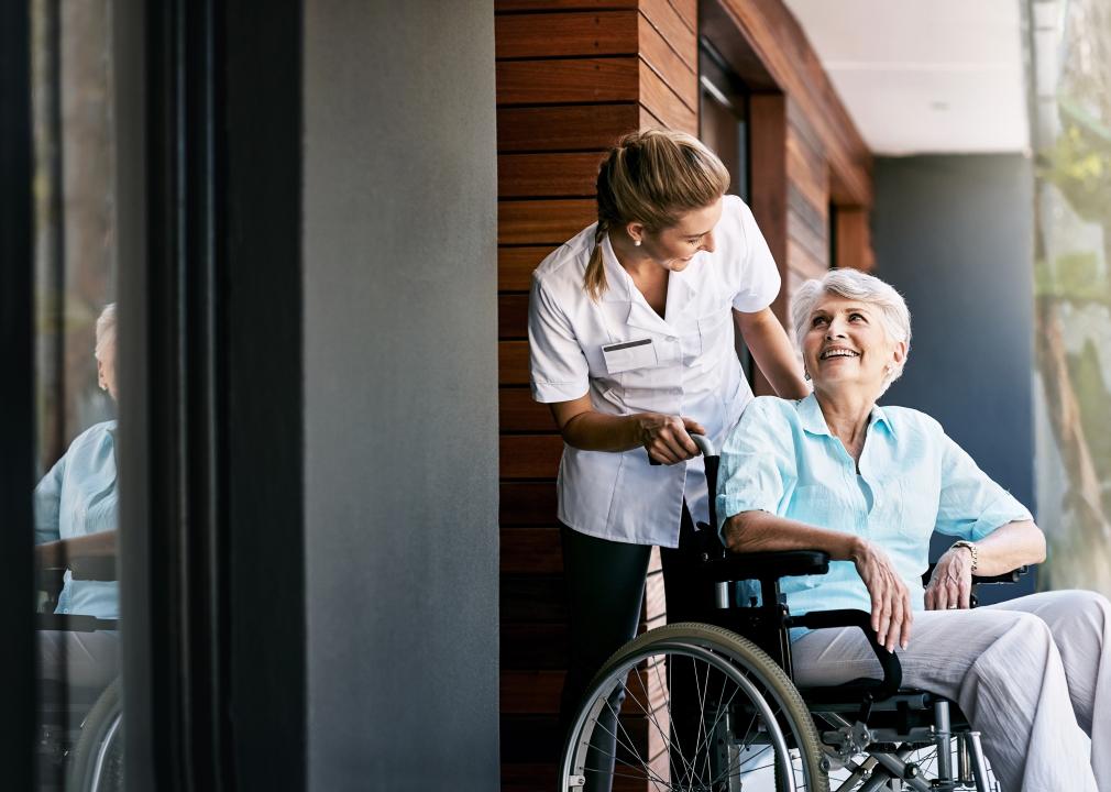 Health care worker talking to senior woman in wheelchair