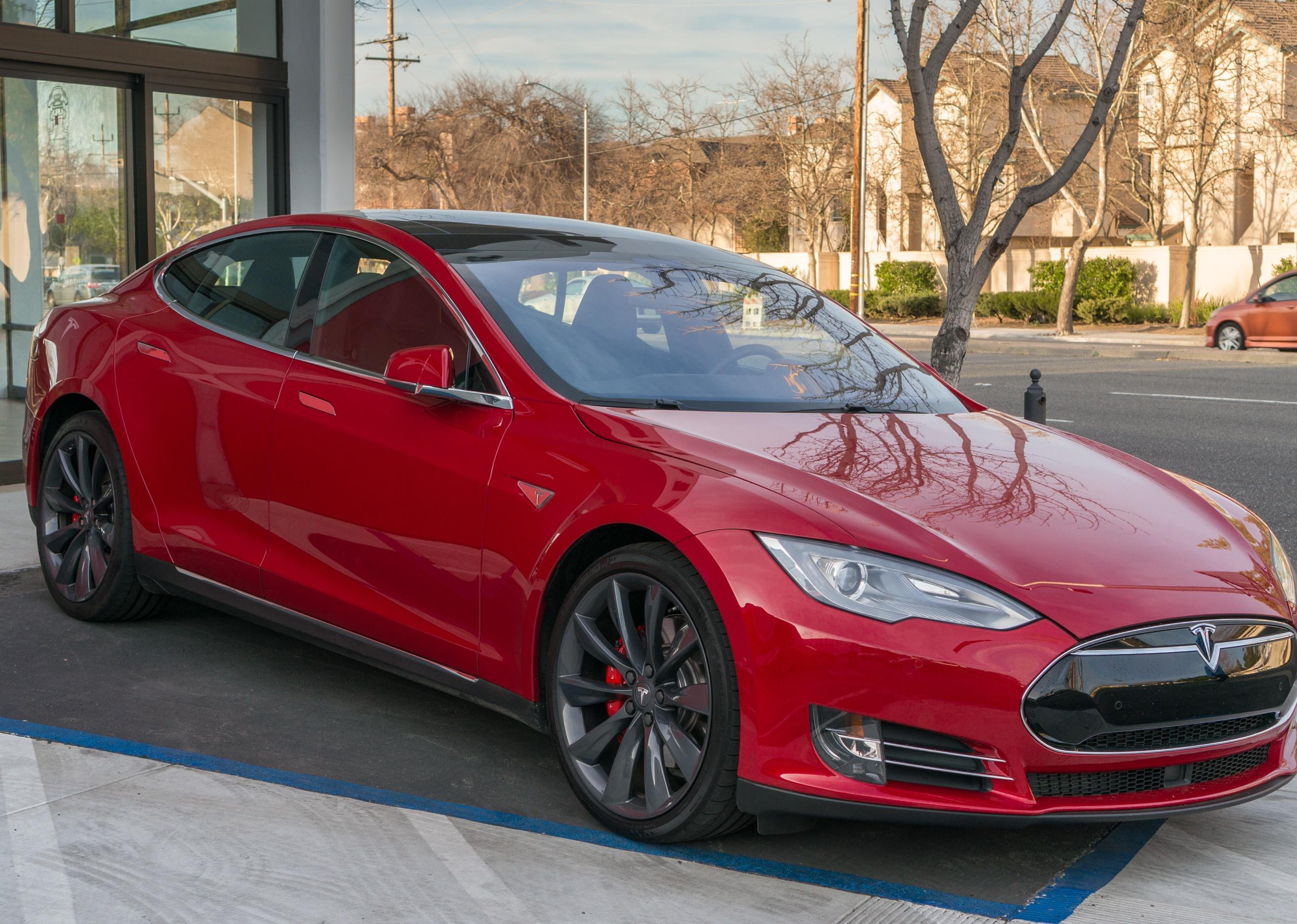 A red Tesla Model S on display outside. 