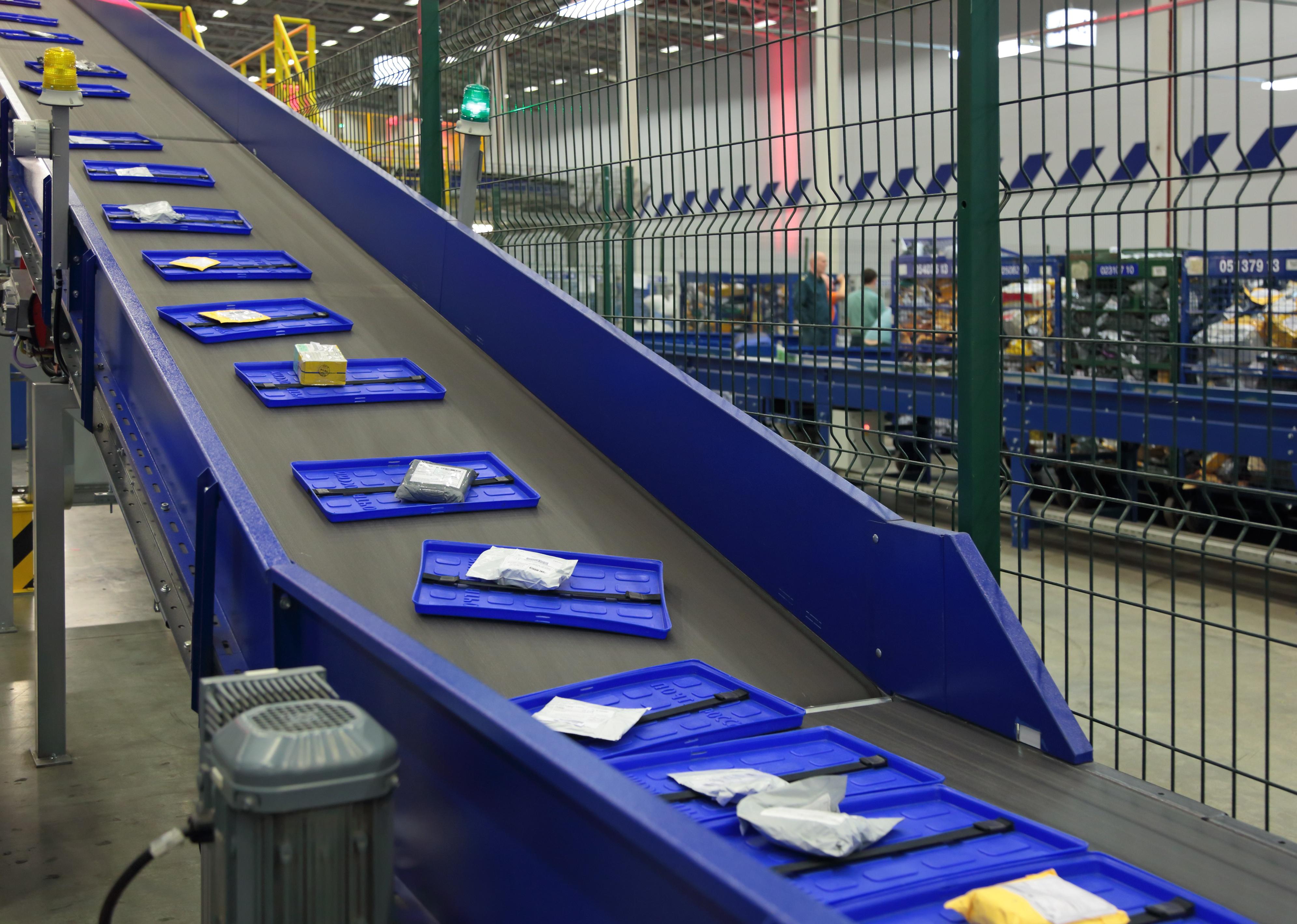 Mail traveling on the conveyor belt.