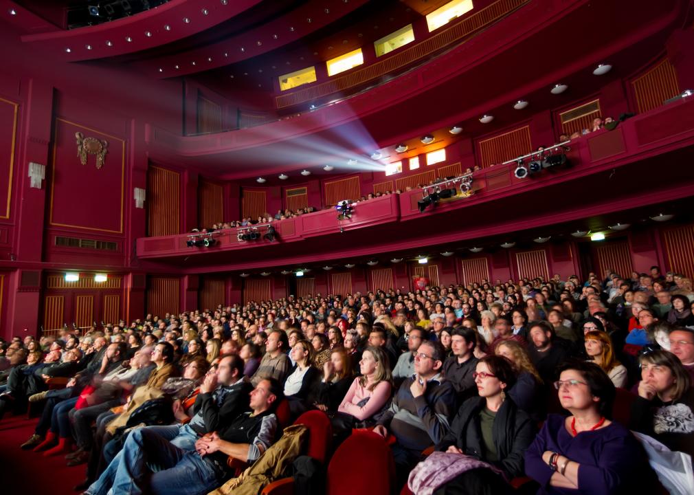 People during a film festival screening in a multitiered theater.