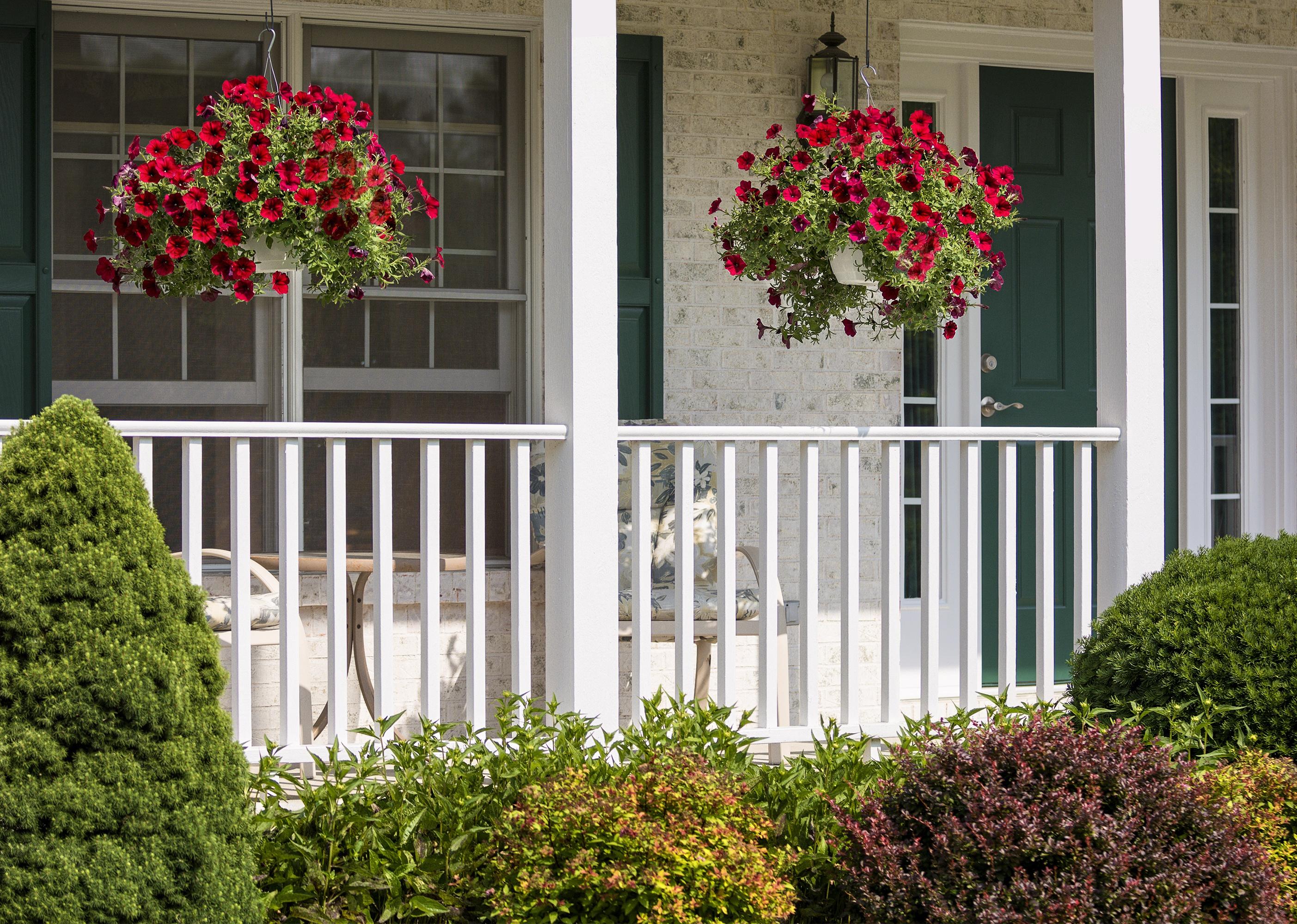 A front porch with hanging flower baskets.