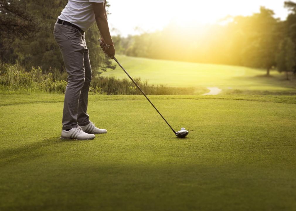 Person playing golf on green.