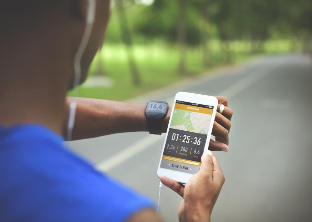 Man looking at watch and phone fitness activity