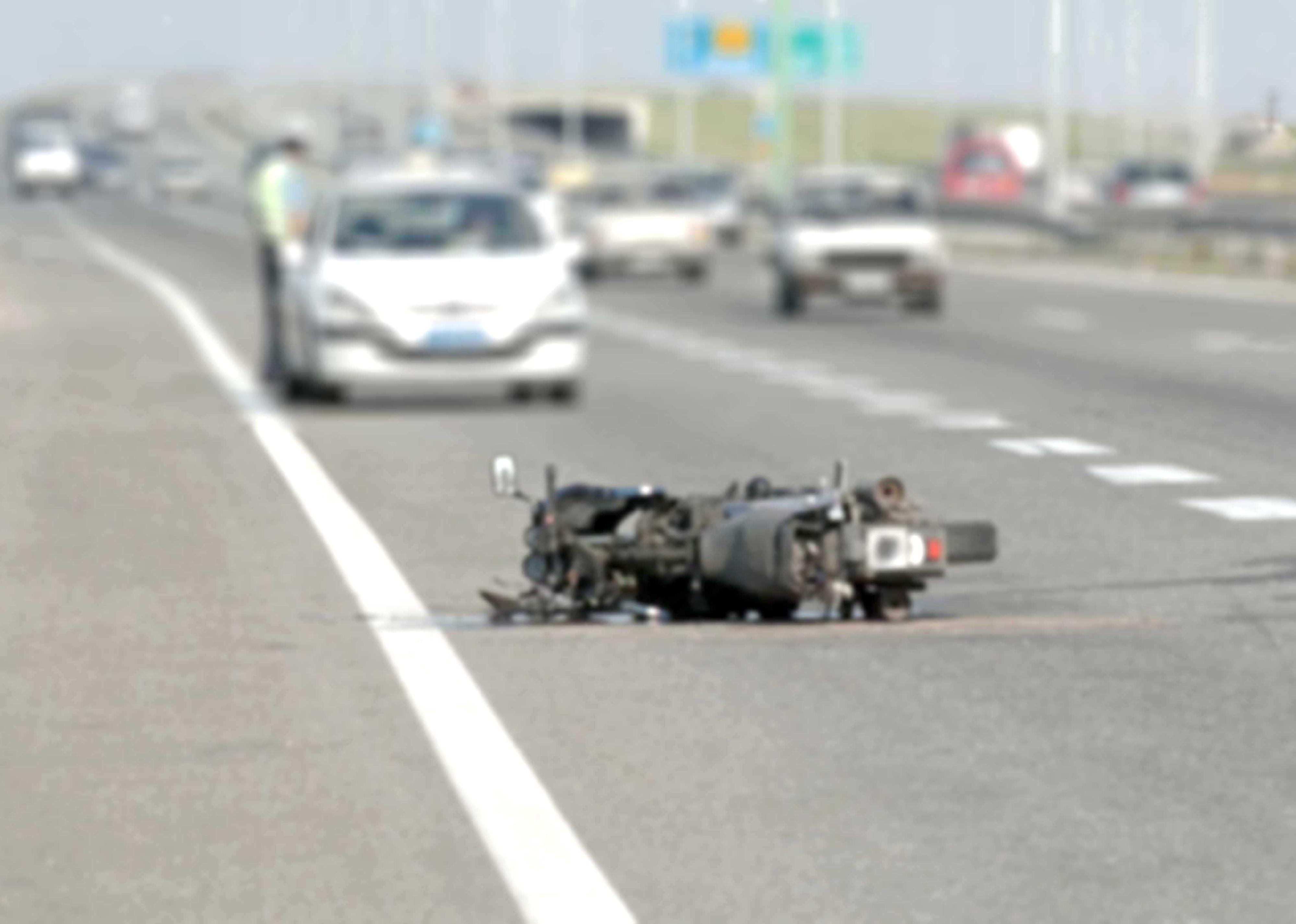 Blurred photo of a motorcyle accident scene.