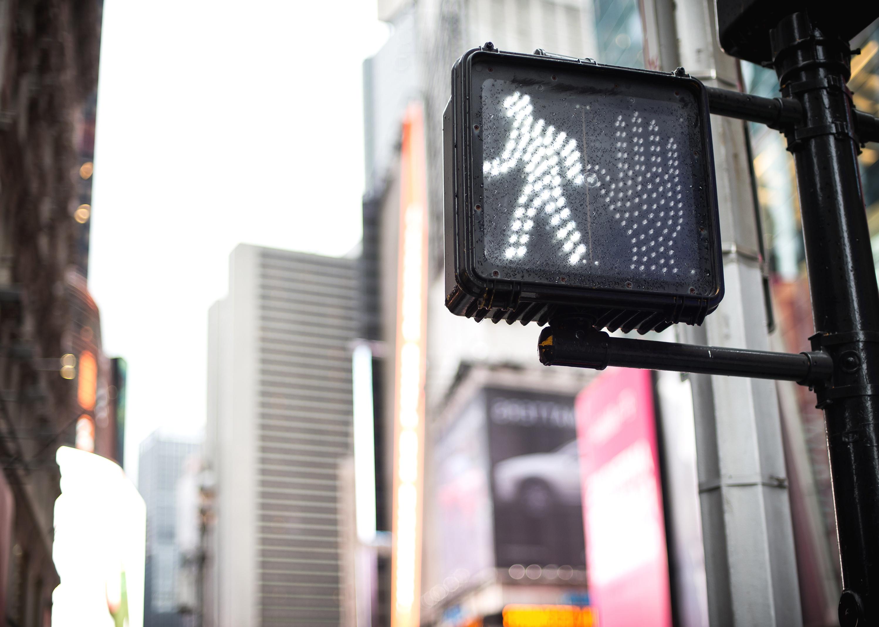 Crosswalk sign on a Manhattan traffic light.