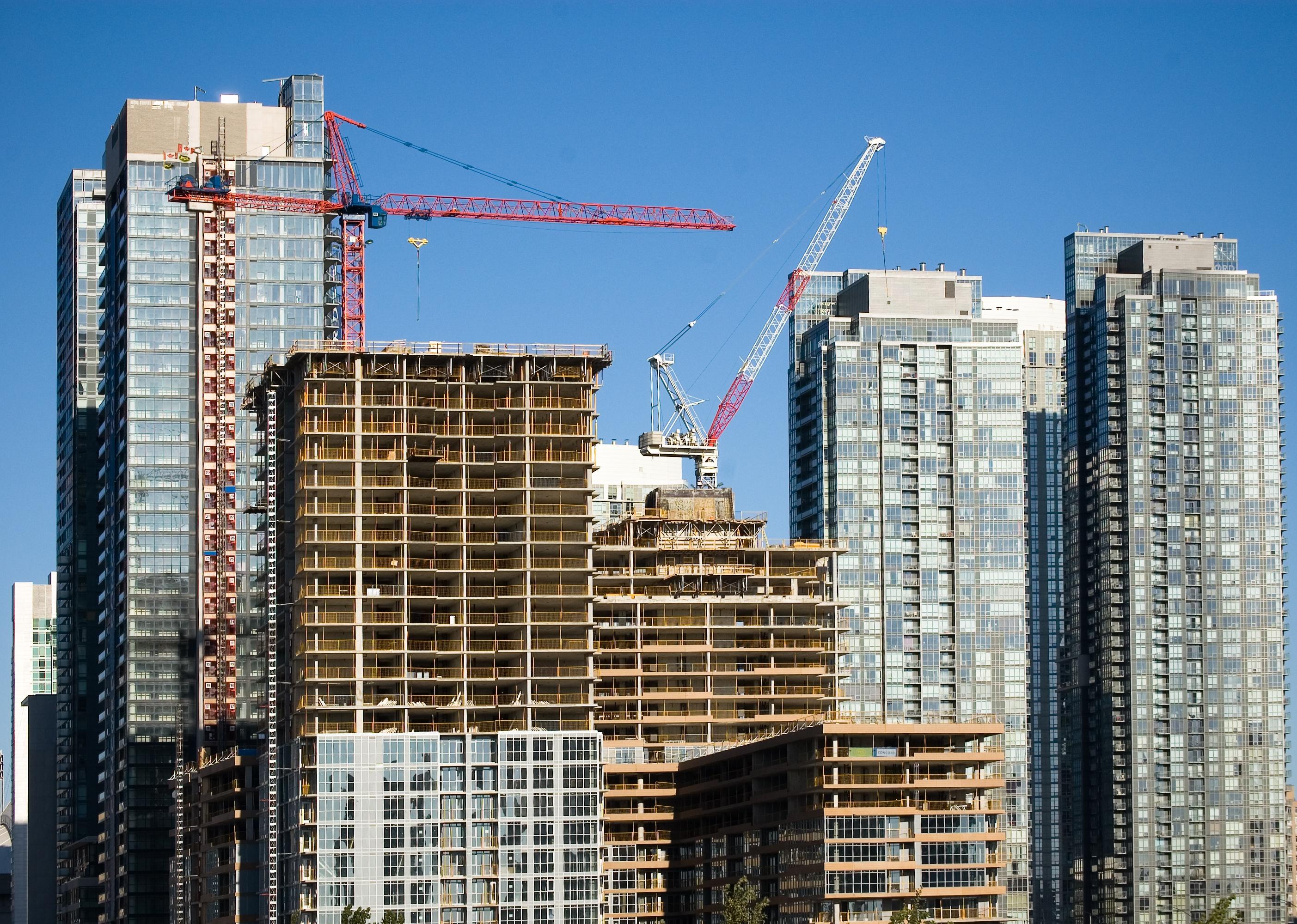 Crane on top of high rise in Toronto.