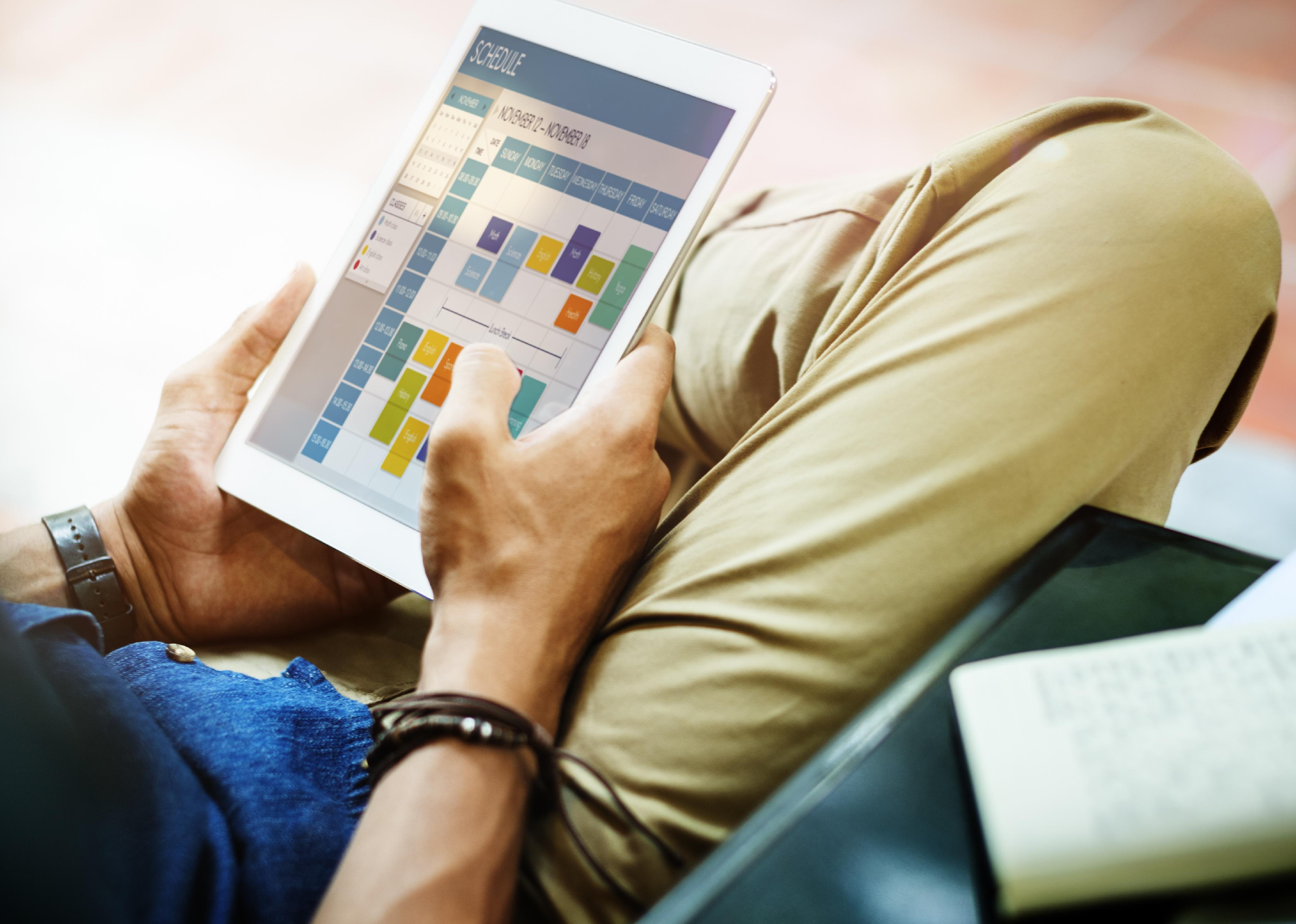 Man looking at a calendar on a tablet