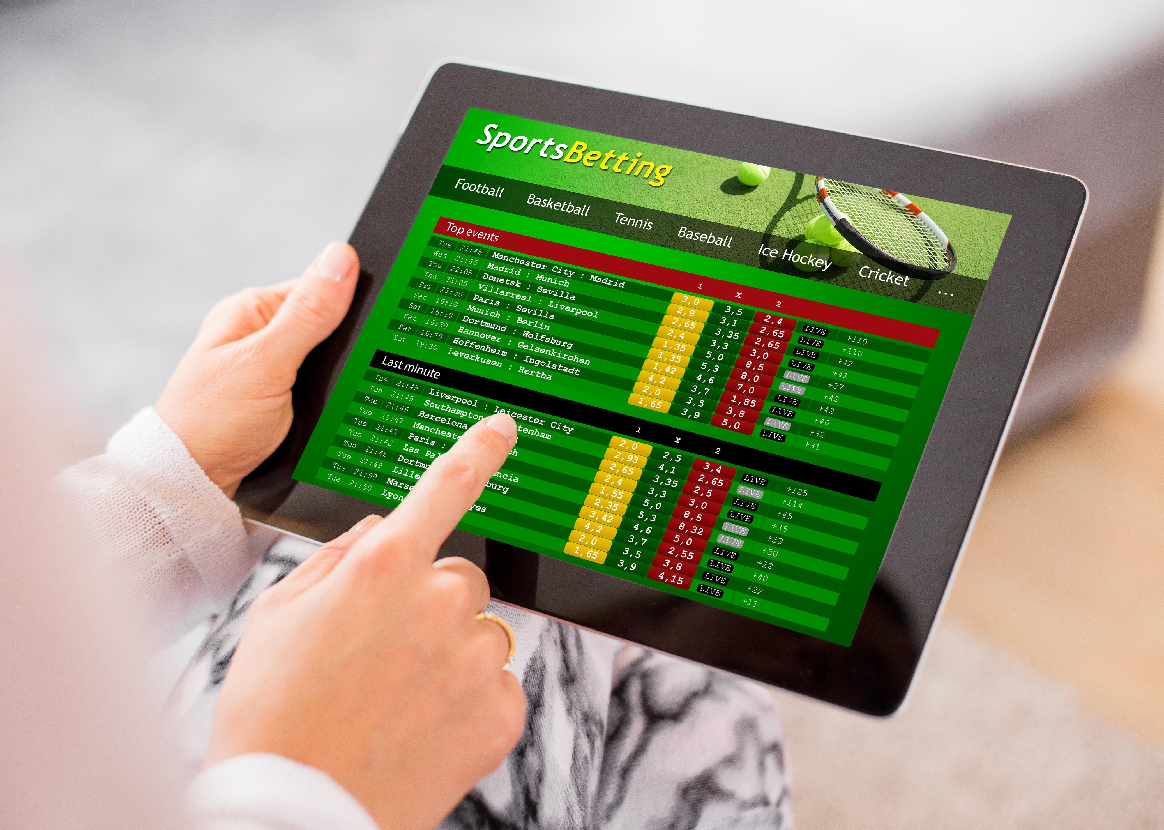 Sports betting app on tablet computer.