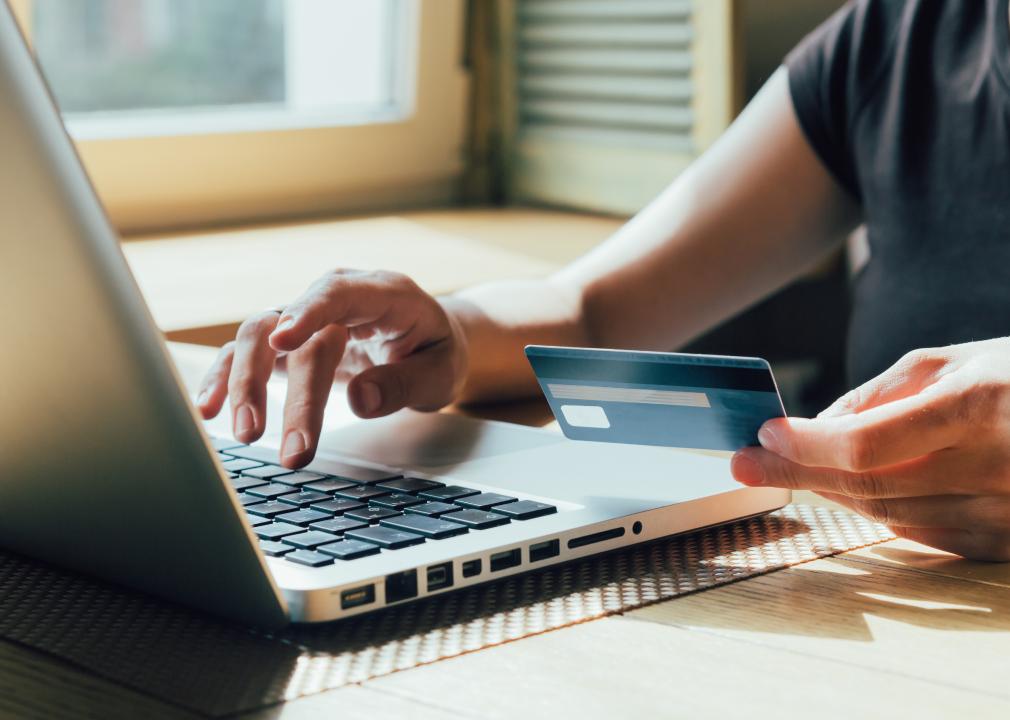 Woman makes a purchase on the computer with credit card