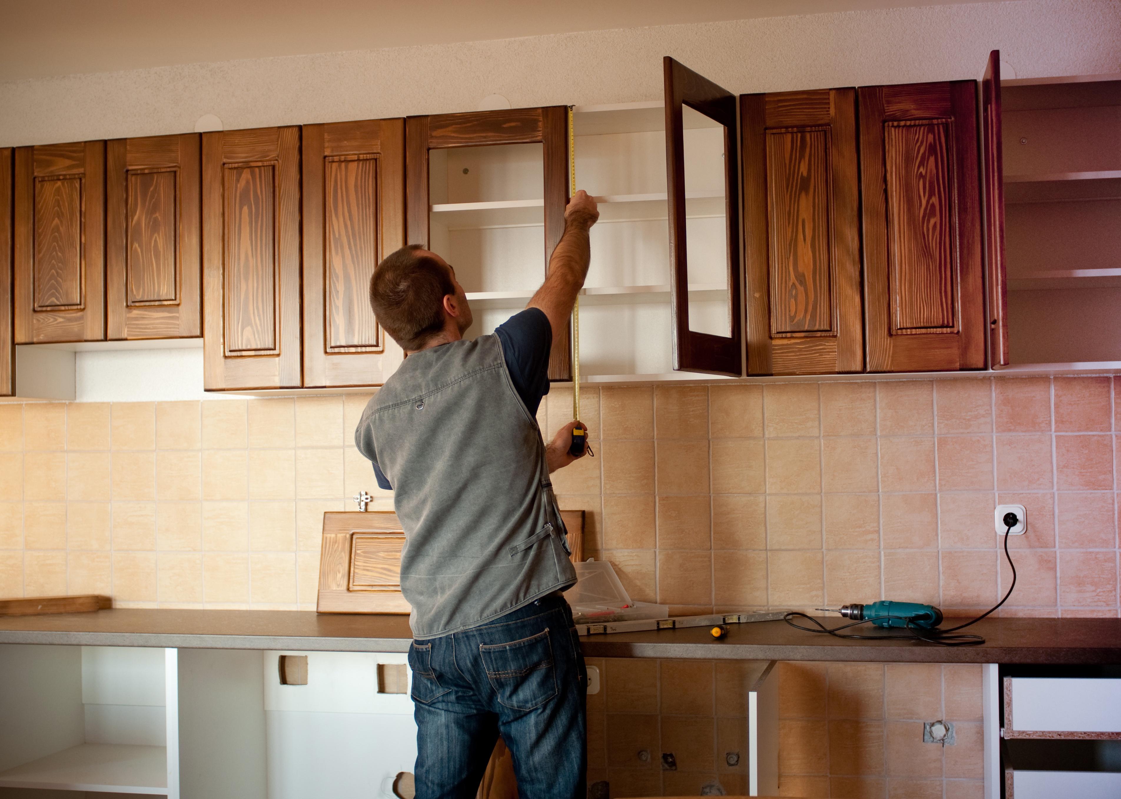 Carpenter working on new kitchen cabinets.