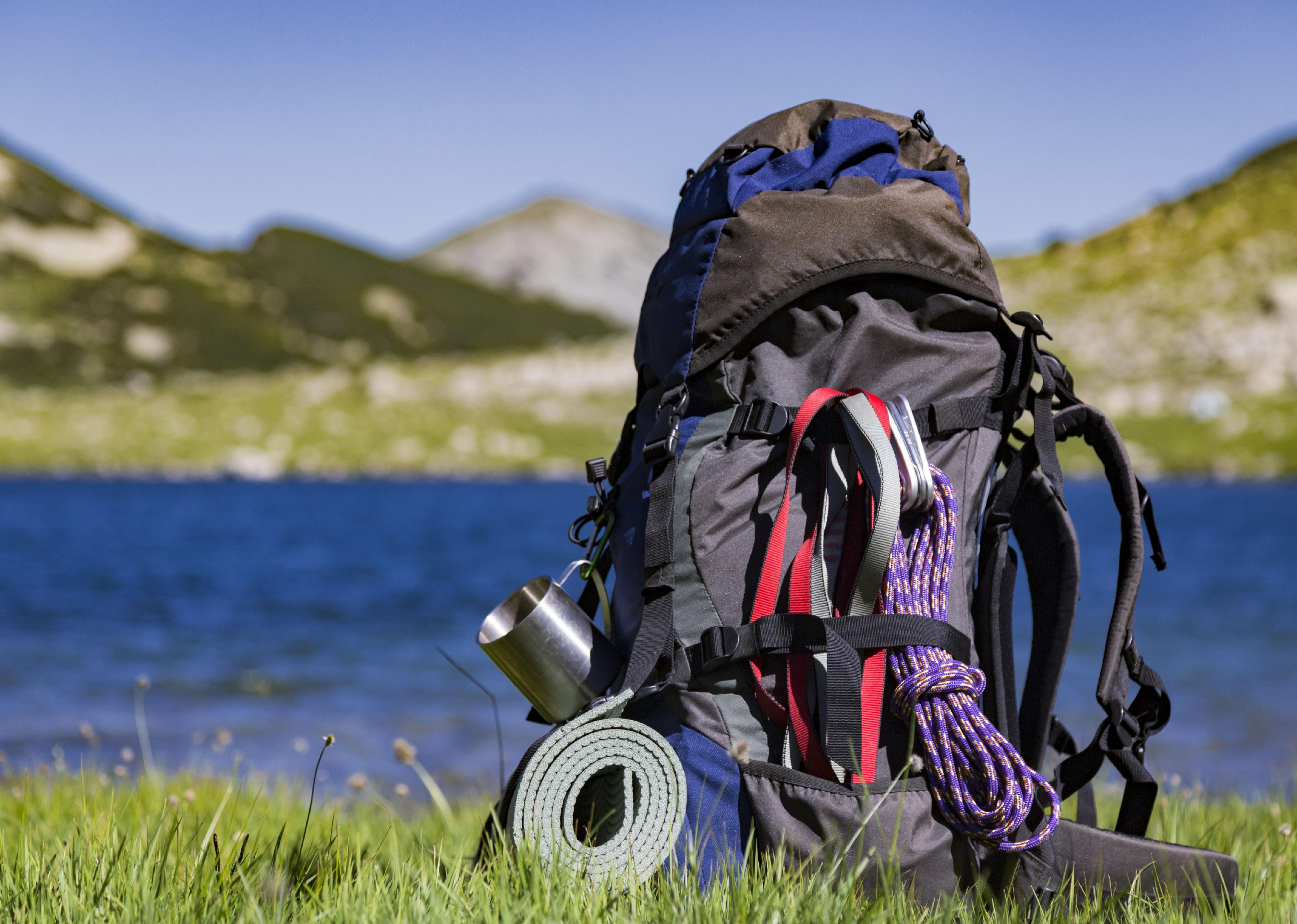 Hiking backpack sitting up on water's edge