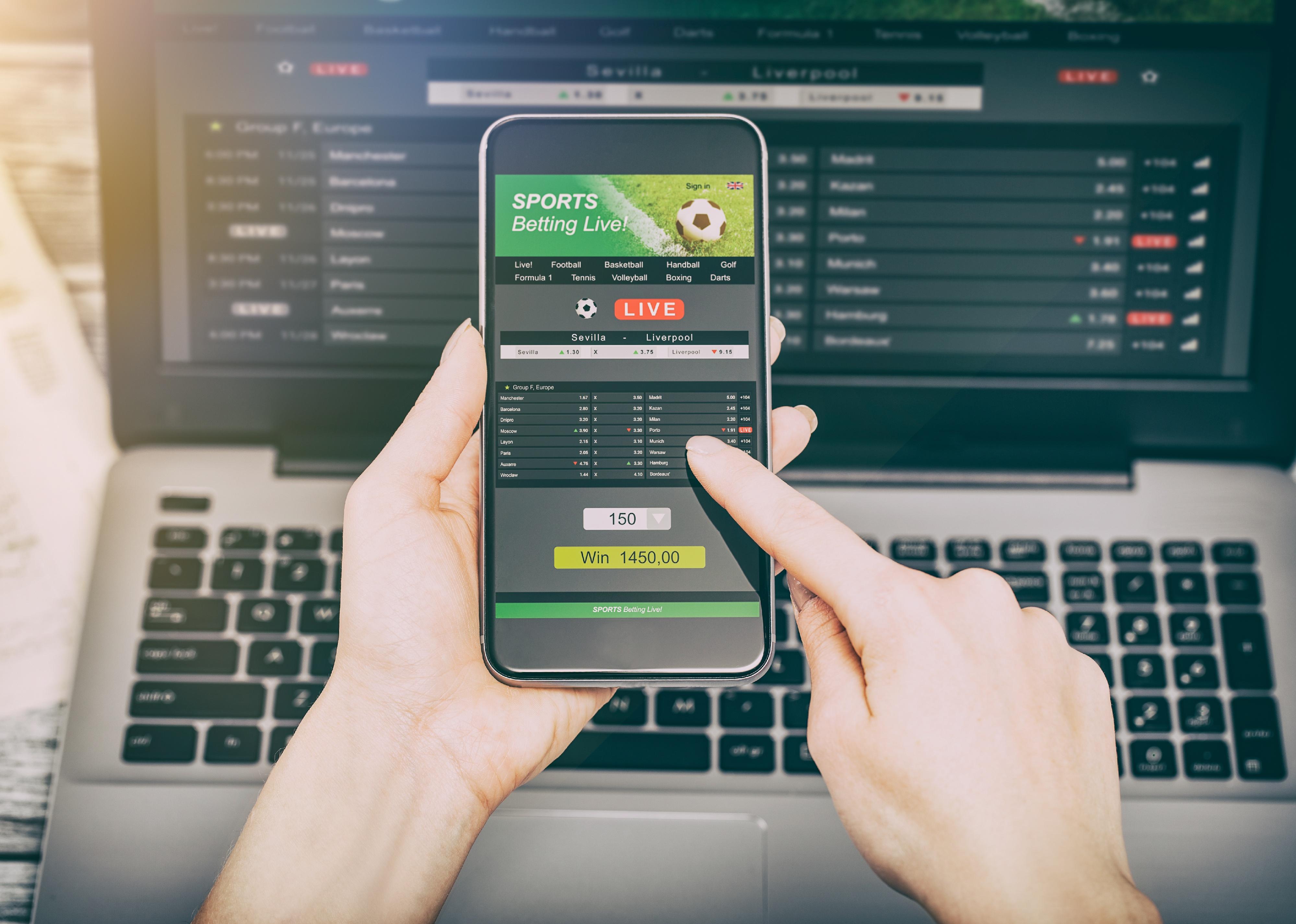 Hands on betting app on a phone.