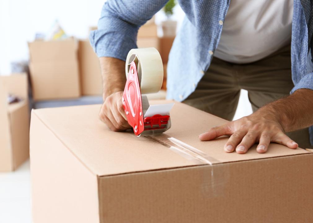 Closeup of man packing cardboard box