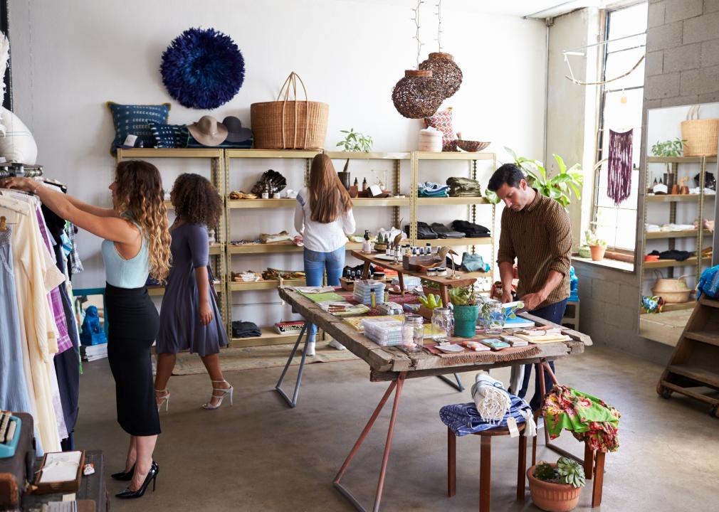 Customers and staff in a busy clothes shop