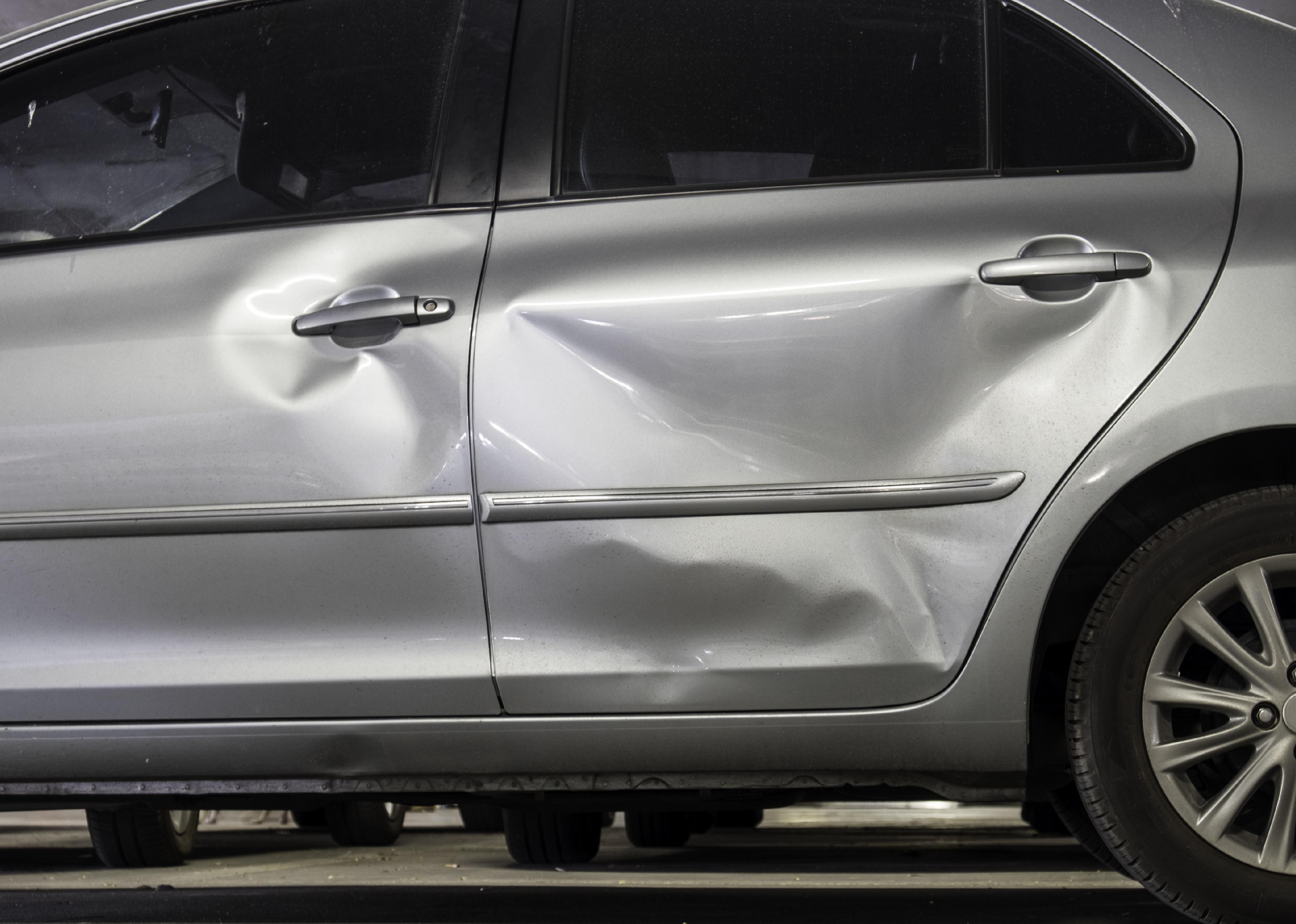 Car with damage to its left side doors