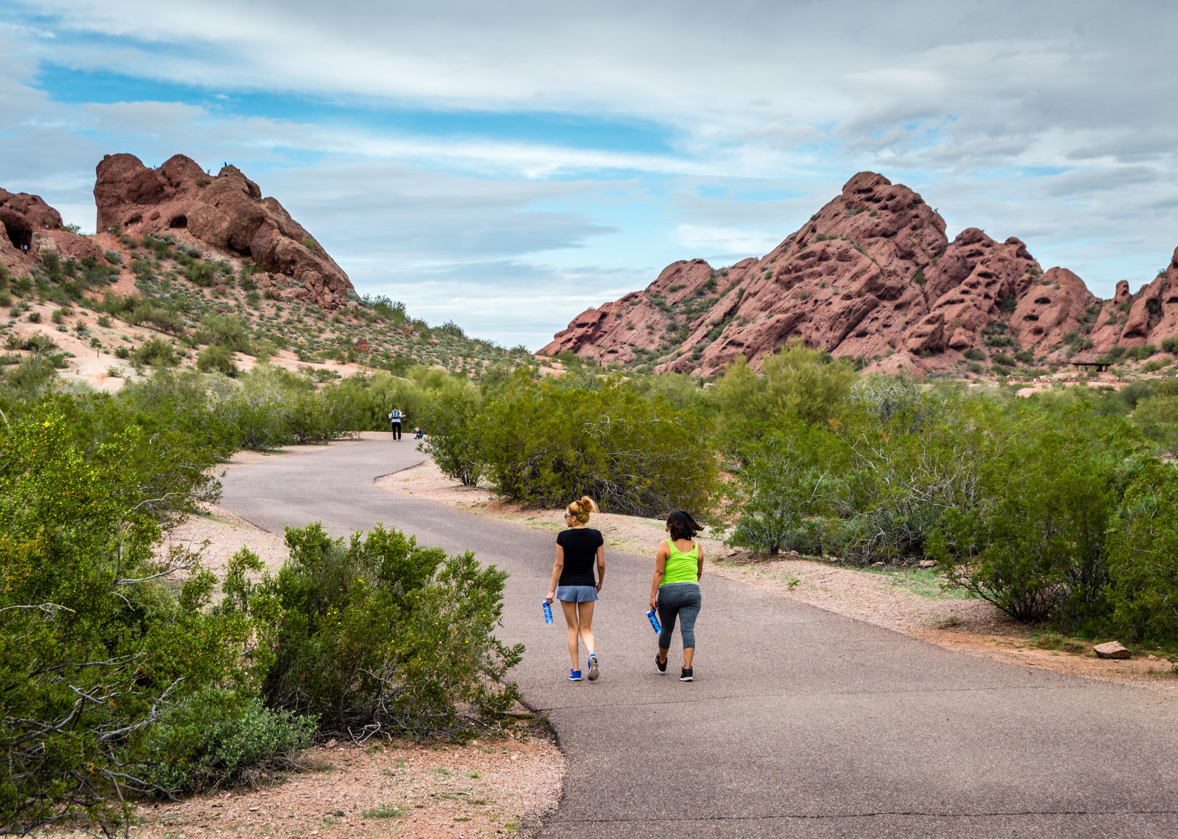 Two women following the trail towards the sandstone buttes of Papago Park in Phoenix.