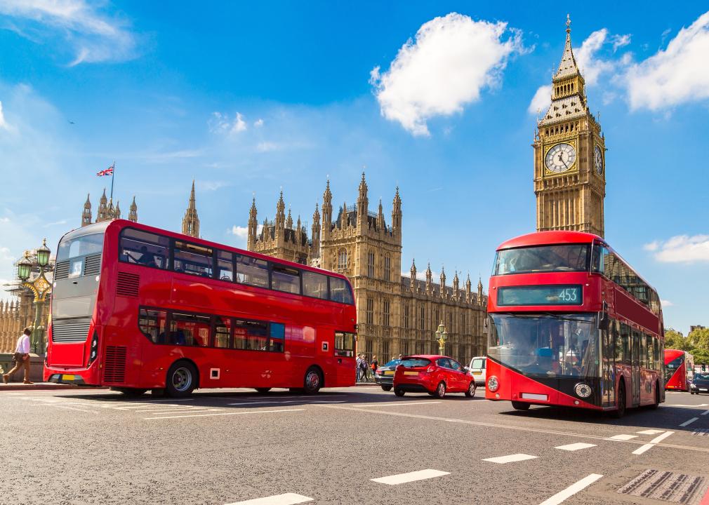 Big Ben, Westminster Bridge, and a red double decker bus on a sunny day.