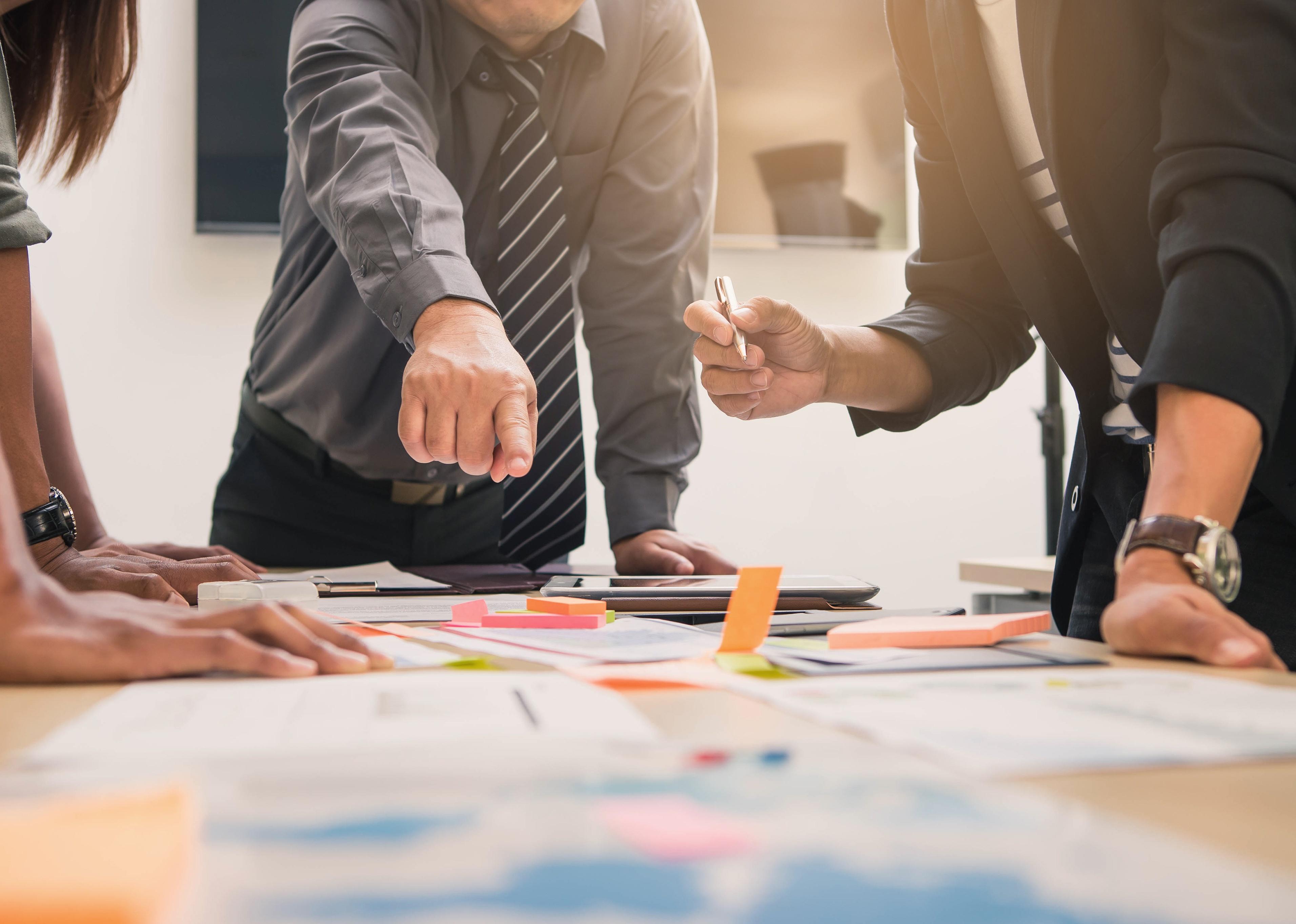 Group of people around a table in a business meeting. 
