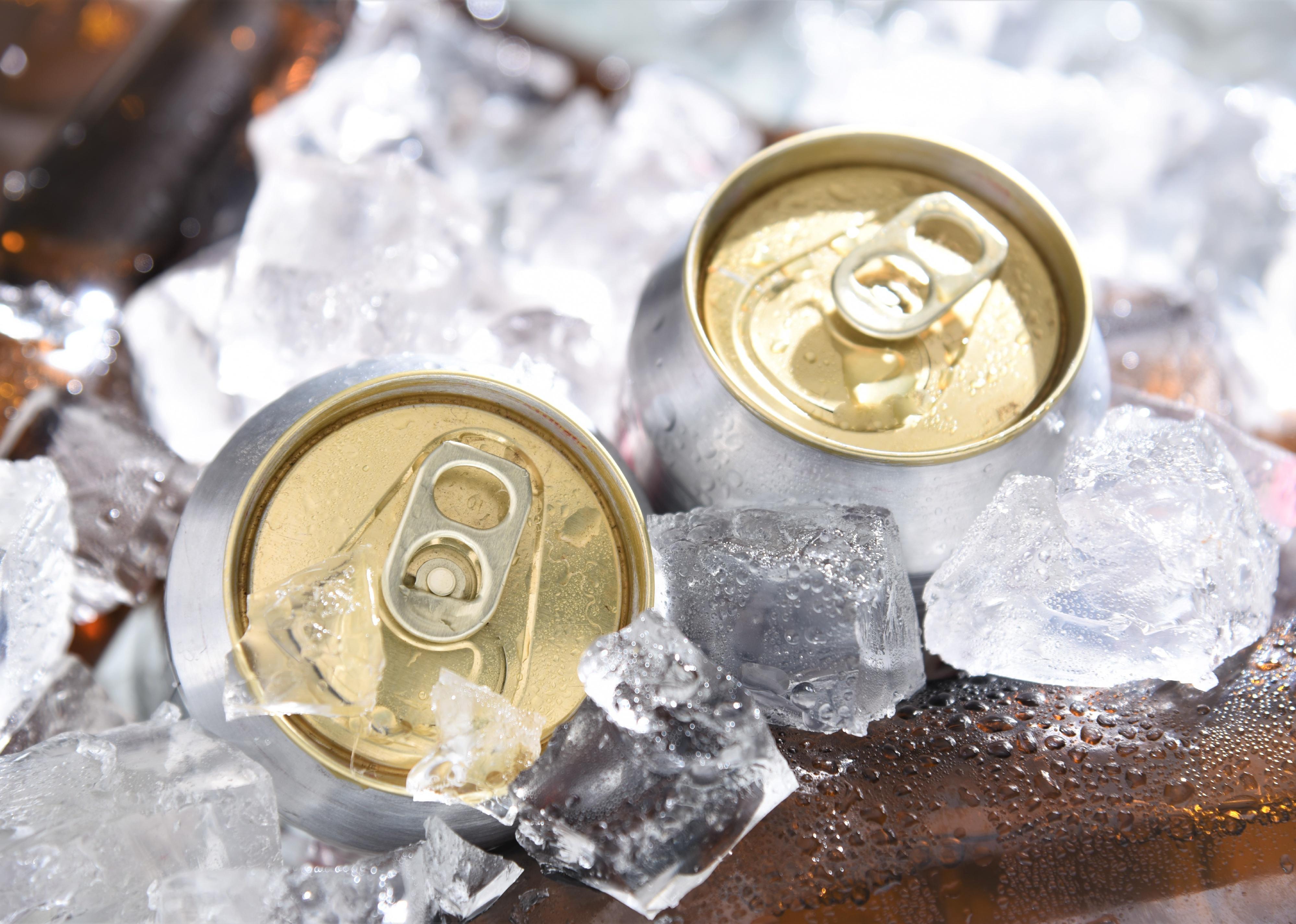Beer cans chill in ice