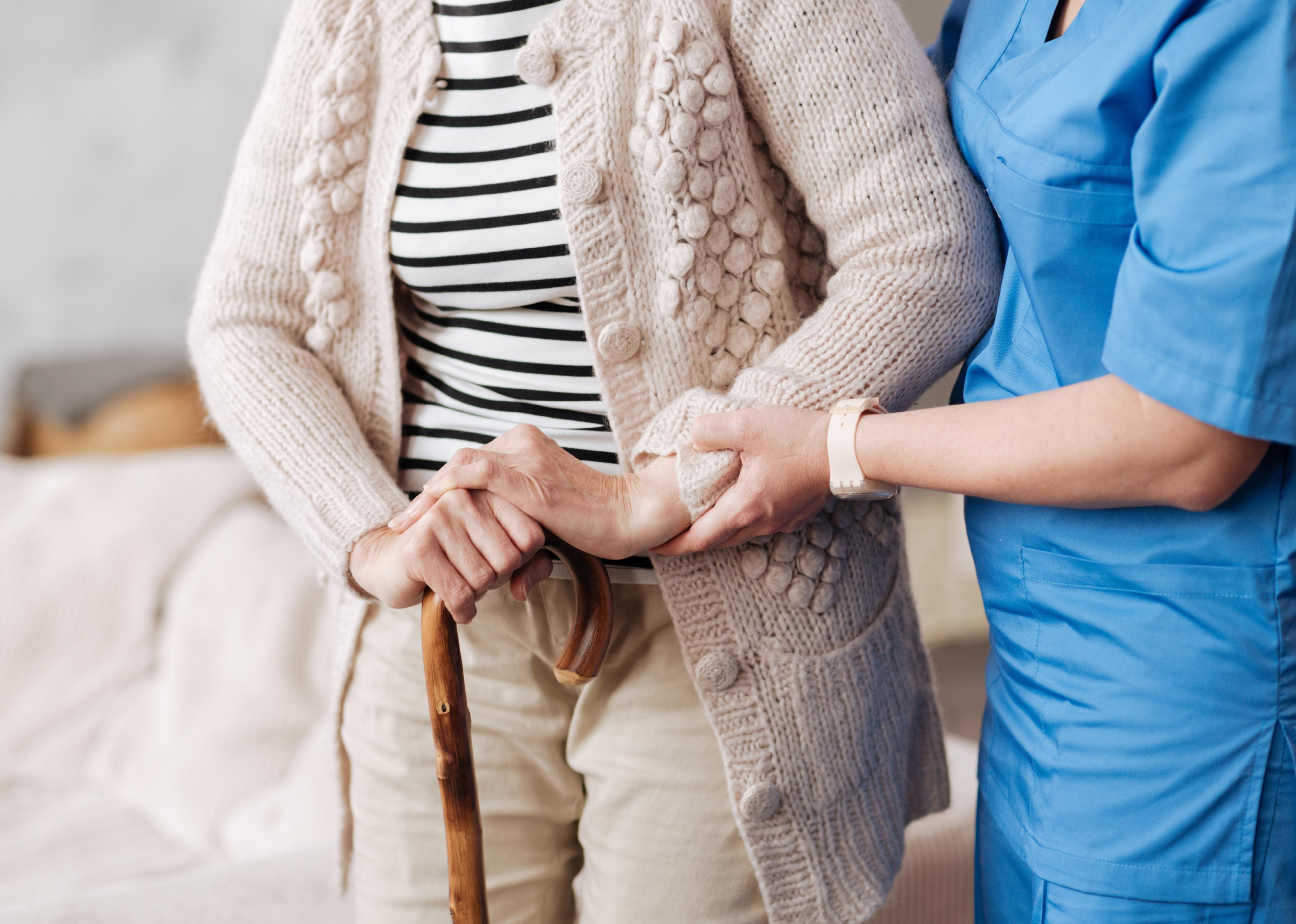 Close up of a nurse helping a patient.