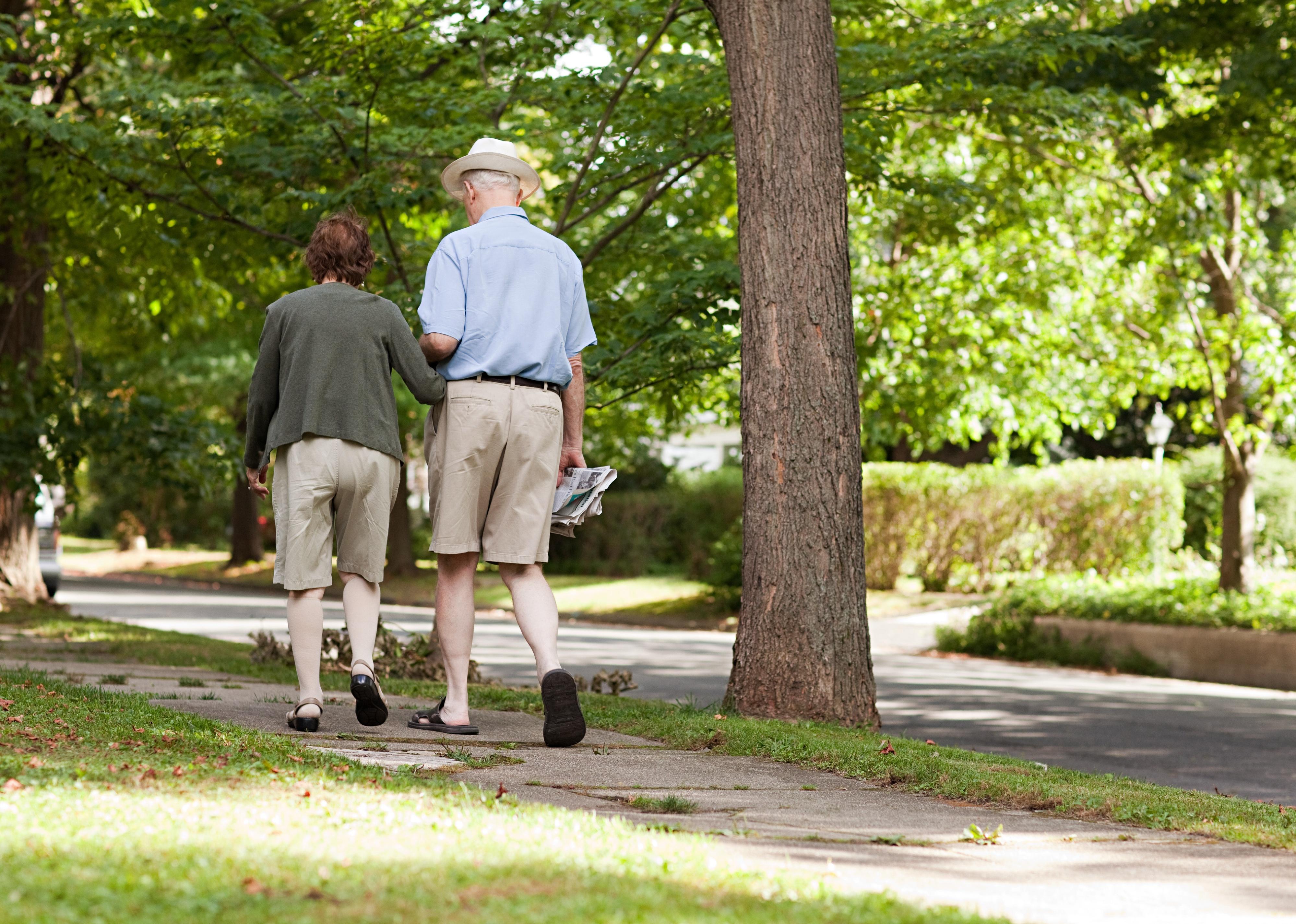 Senior couple walking in neighborhood.