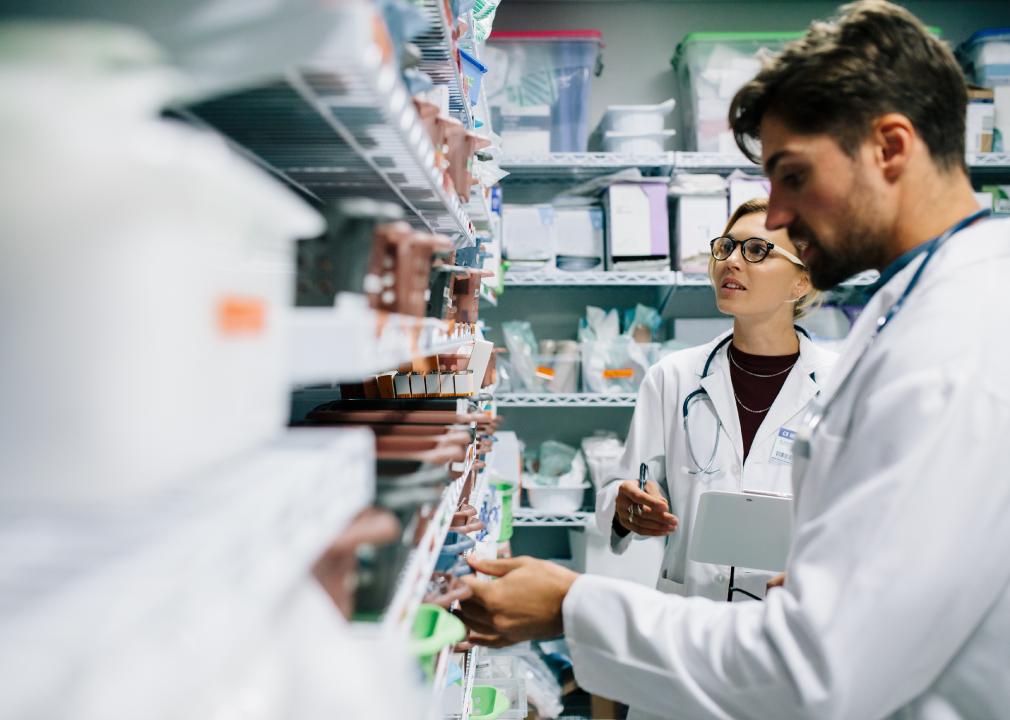 Two pharmacists working in drugstore.