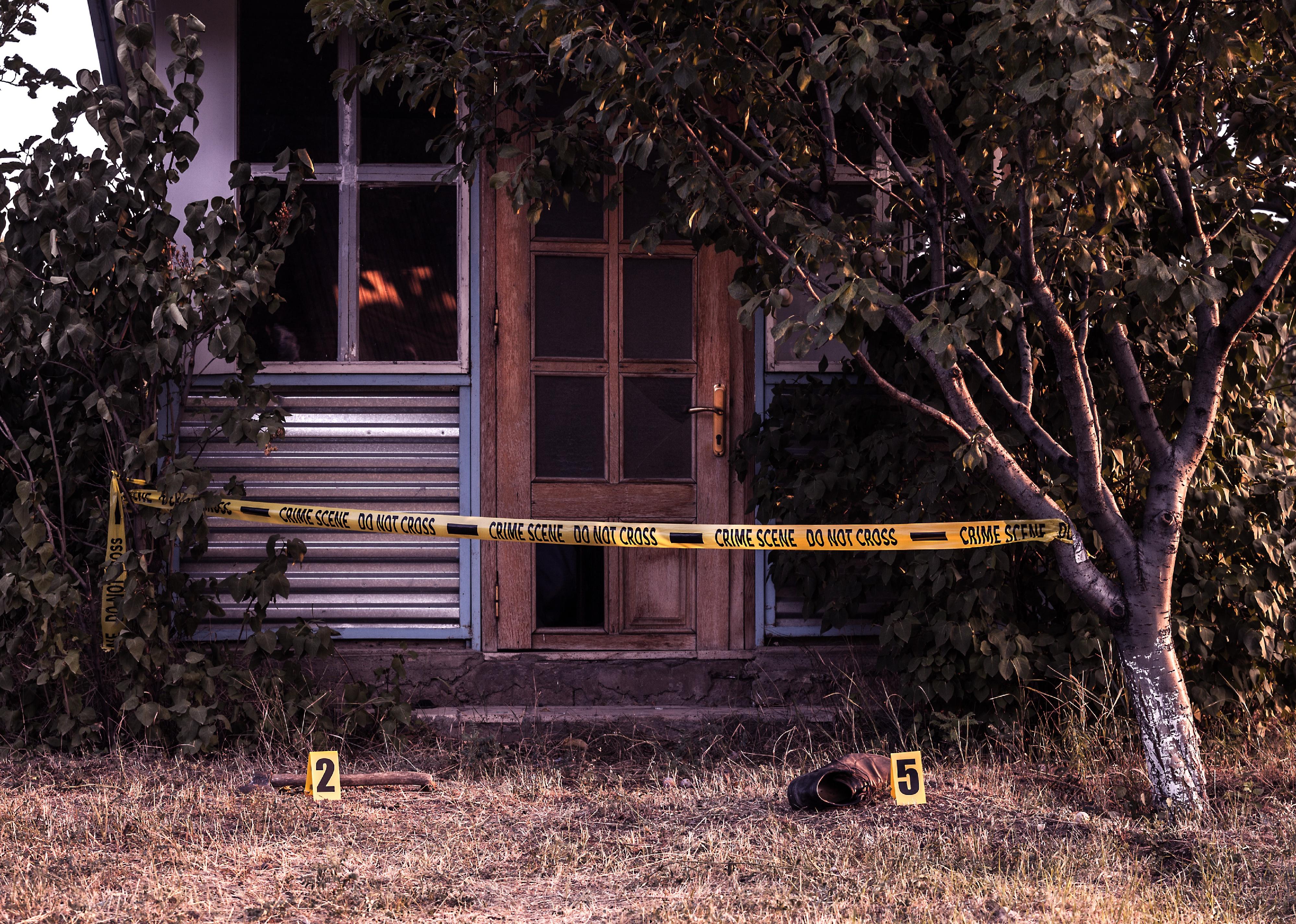 Crime scene tape in front of a house.