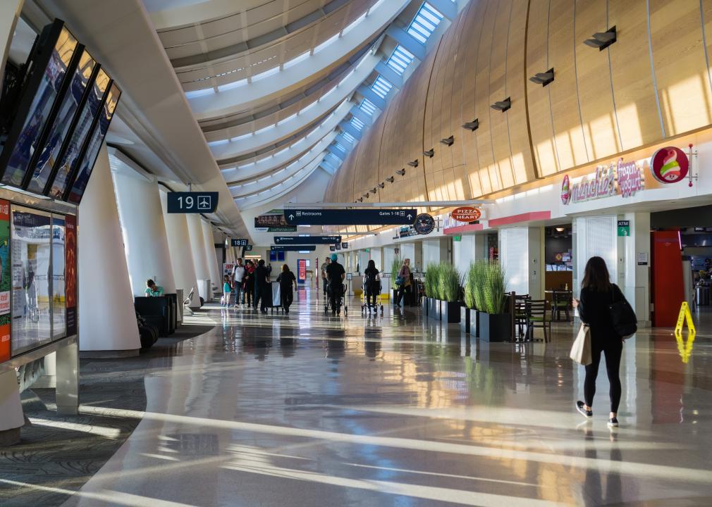 Travelers walking the aisles of Norman Y. Mineta San Jose International Airport.