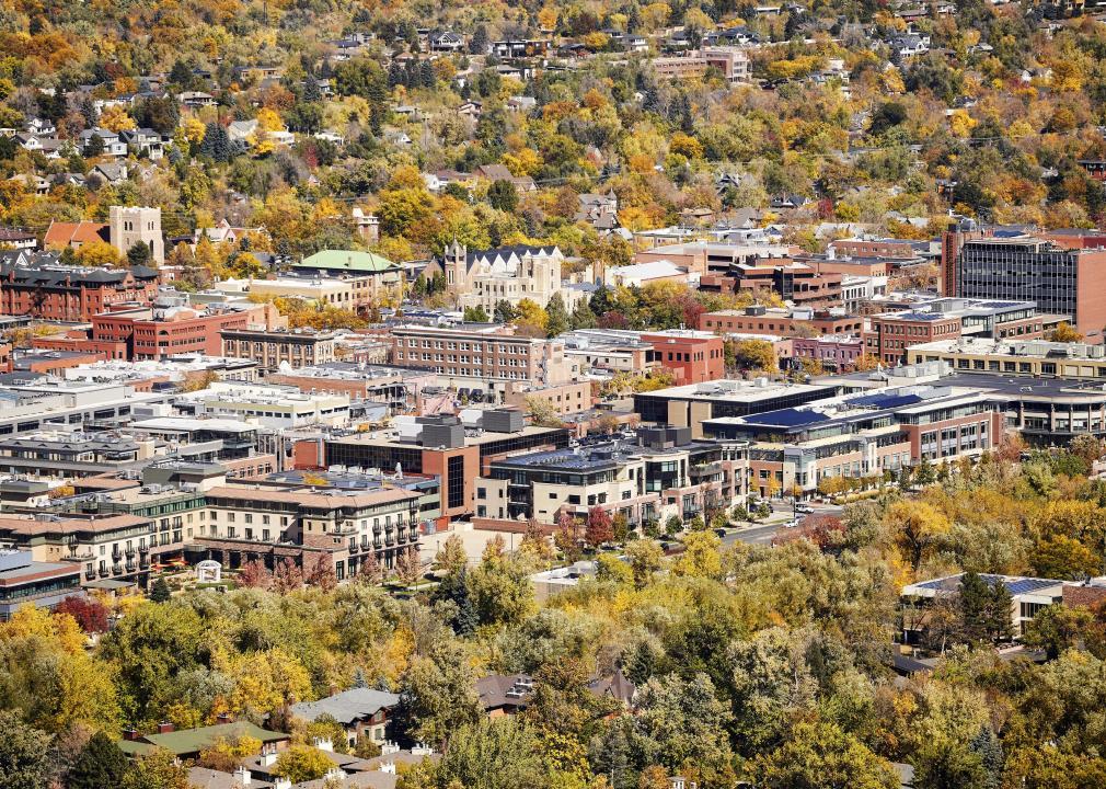 An aerial view of a town center surrounded by autumn foliage. 