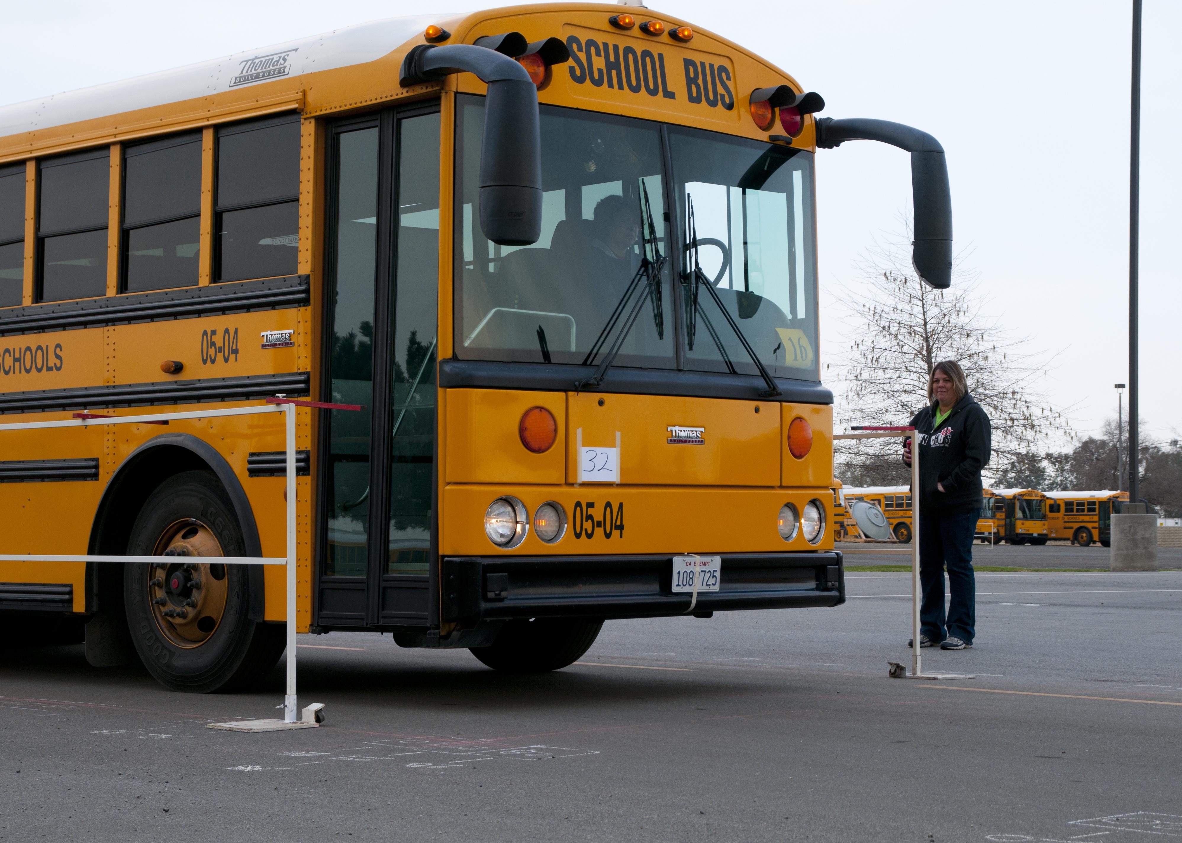 A monitor and school bus wait for students to arrive.