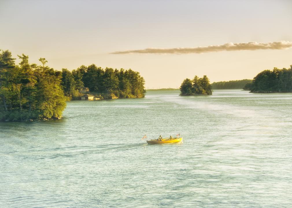 Sunset at Thousand Islands with boat in the water.